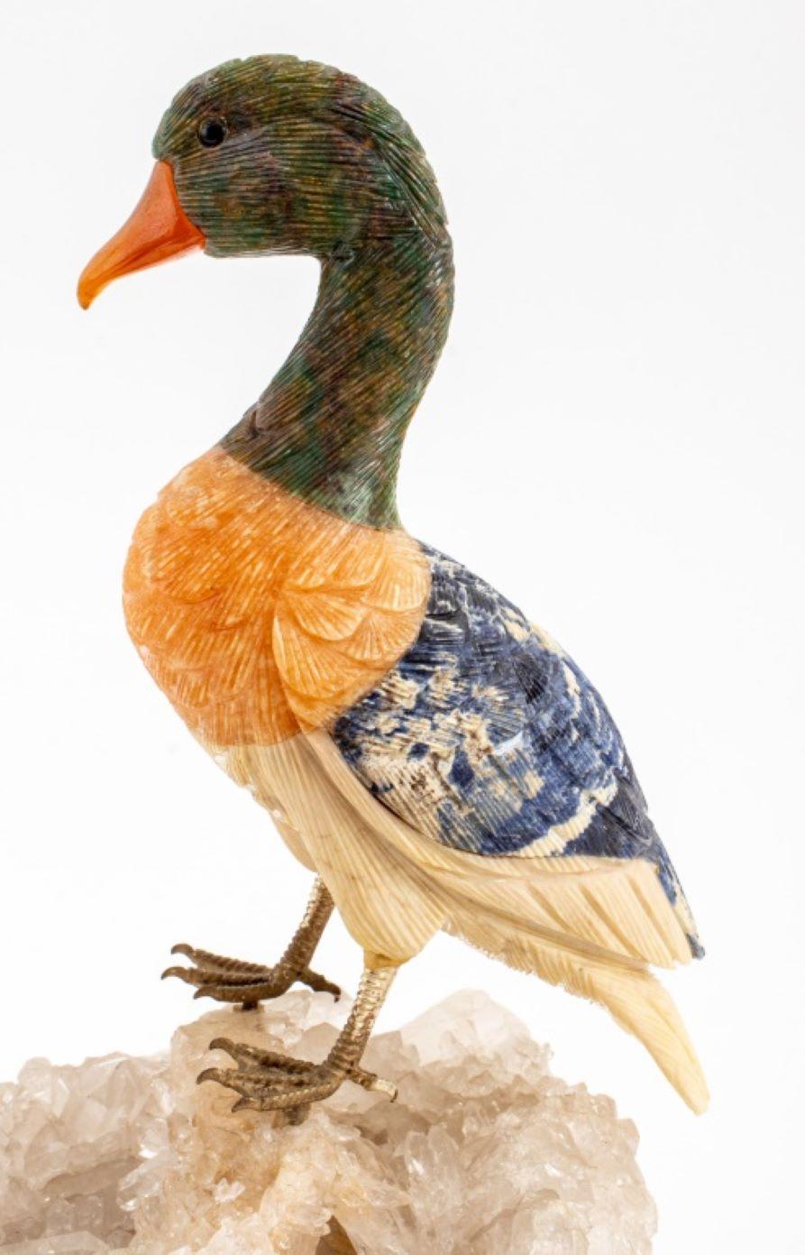 Carved stone duck bird sculpture with inlay of jasper and sodalite mounted atop a clear quartz rock crystal matrix base. 8.75
