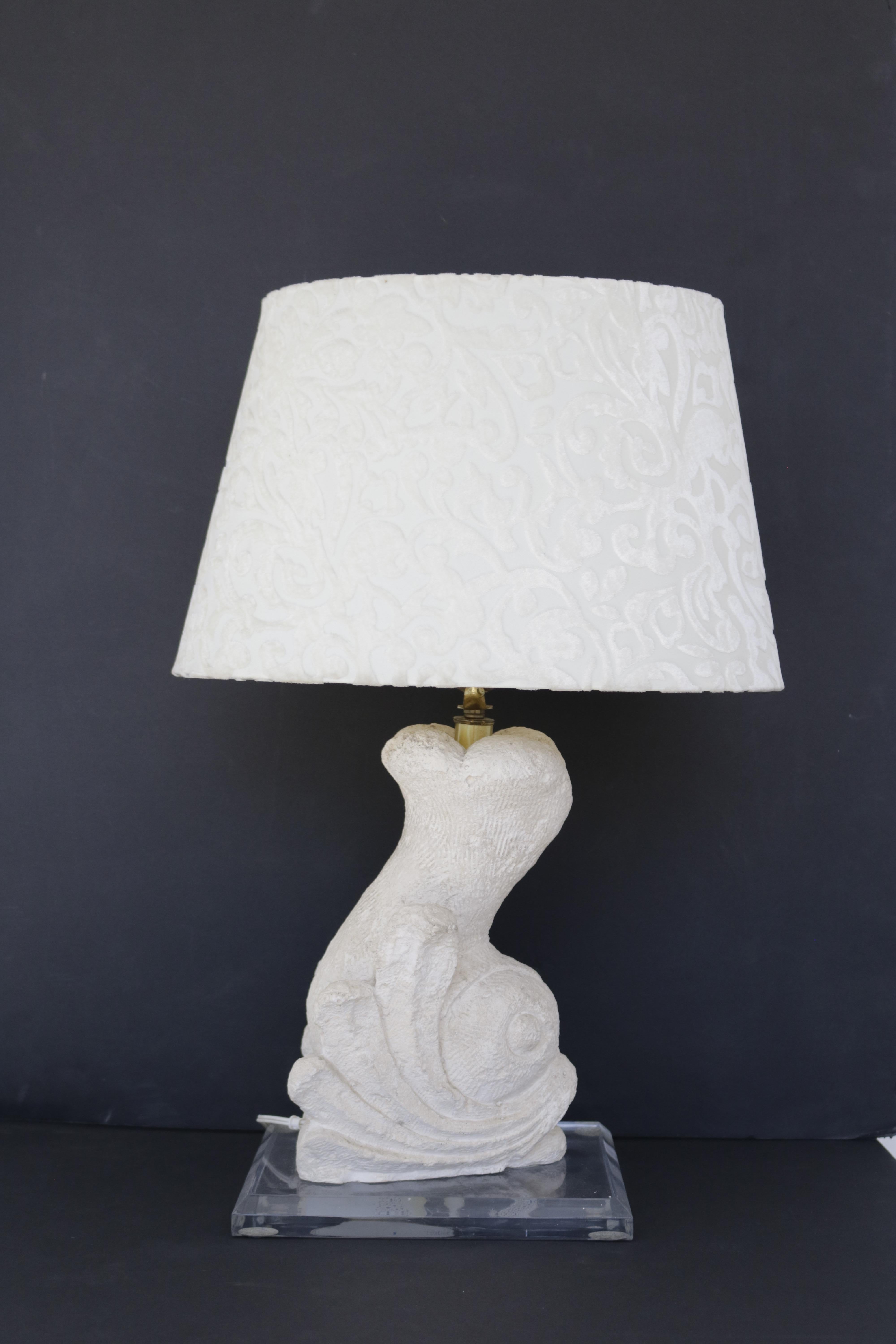 Many interesting textures with this beautifully carved stone lamp, in the shape of a dolphin. Lamp is on a Plexi-glass base and has a cream baroque patterned velvet lampshade.

Measurements:
24