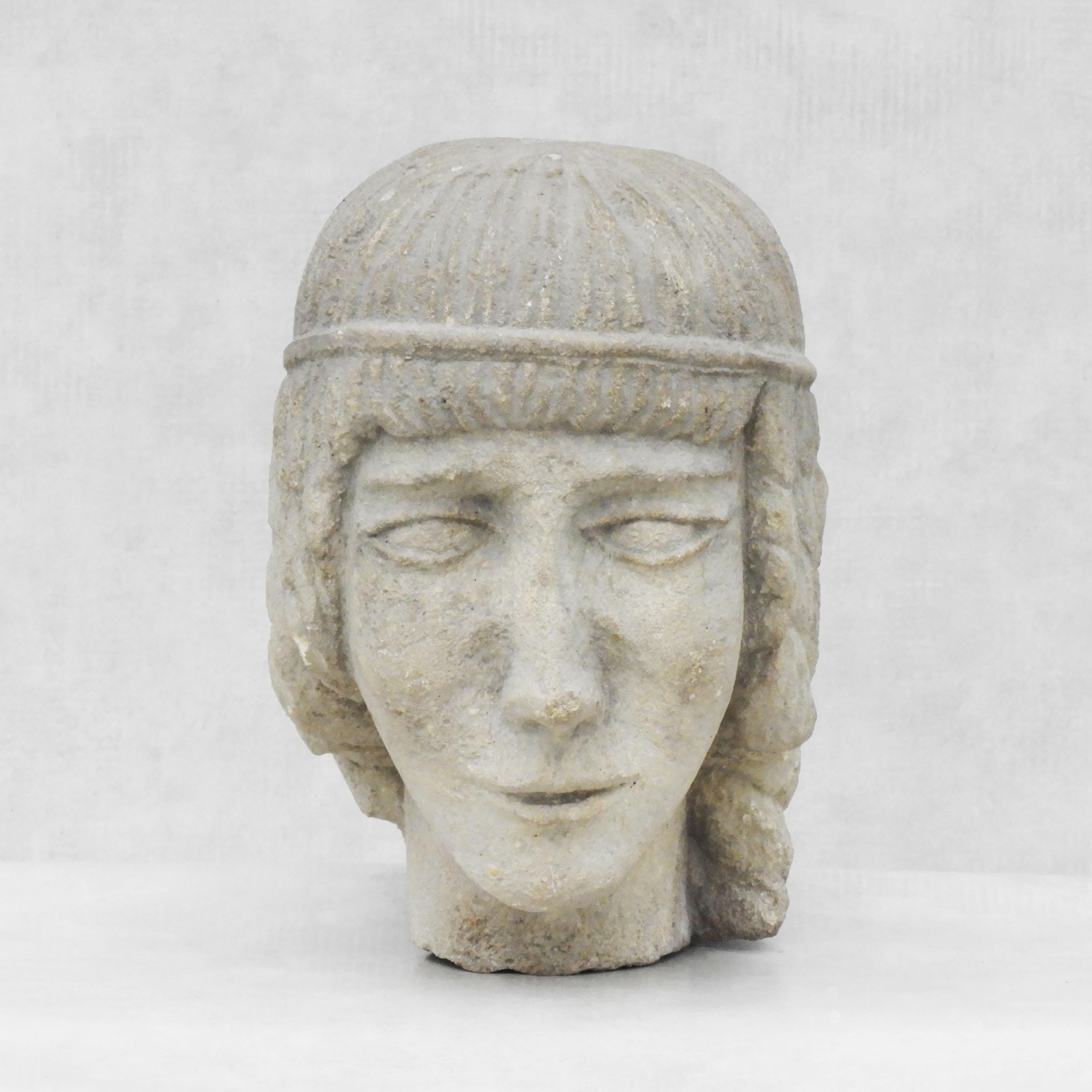 Carved stone female head sculpture c1930s Europe

A stone-carved life-size head sculpture of a young woman by unknown artist.

Well executed with good detailing and nice patina.

Great decorative piece.