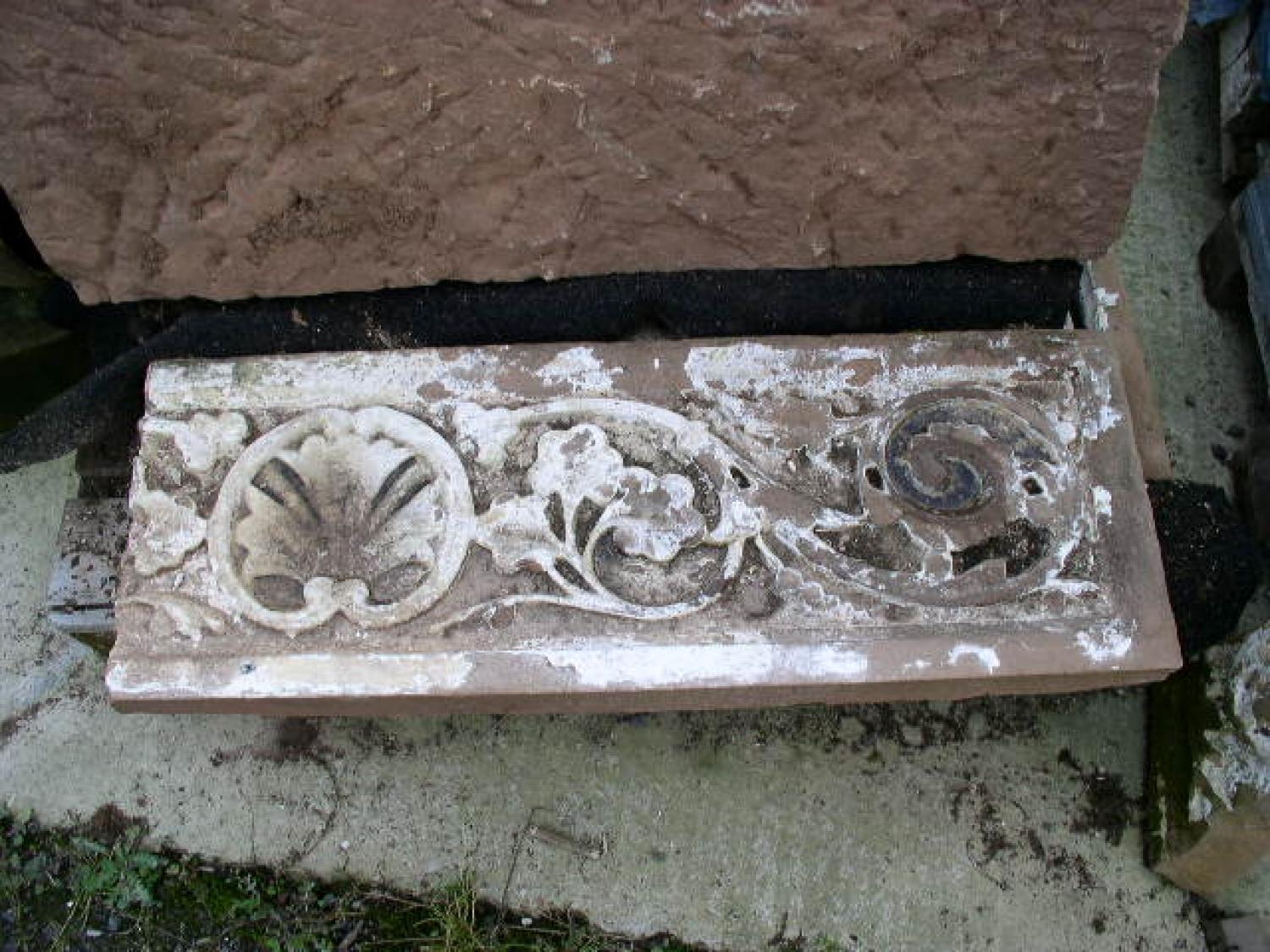 Carved salvaged stone frieze sections from the 20th century.