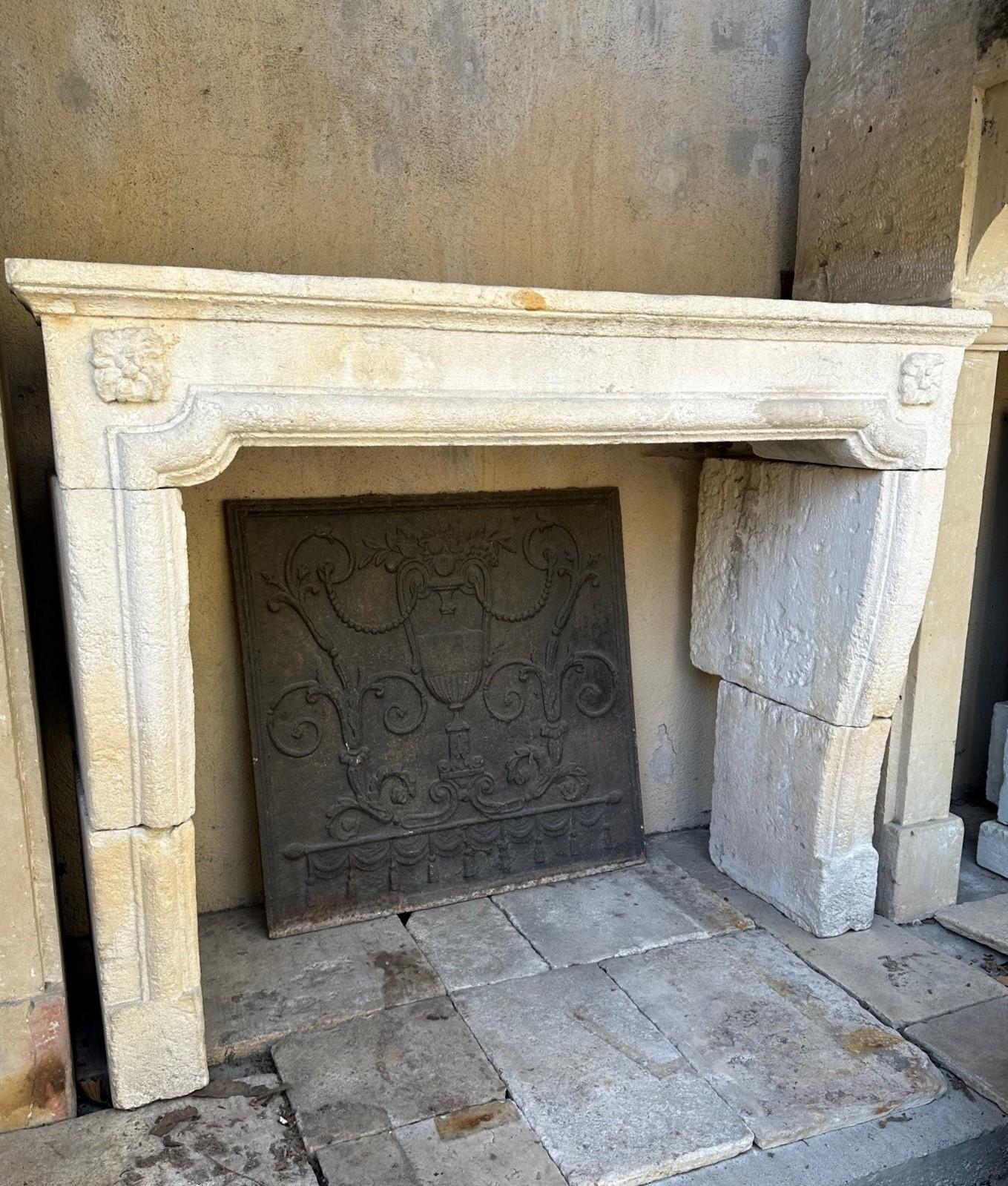 Carved Stone limestone simple fireplace mantle surround Los Angeles antiques CA . A nicely Hand finished carved simple white and off white limestone fireplace mantel (fireplace) surround in the style of Louis XVI with a beautiful sculpted rosette on