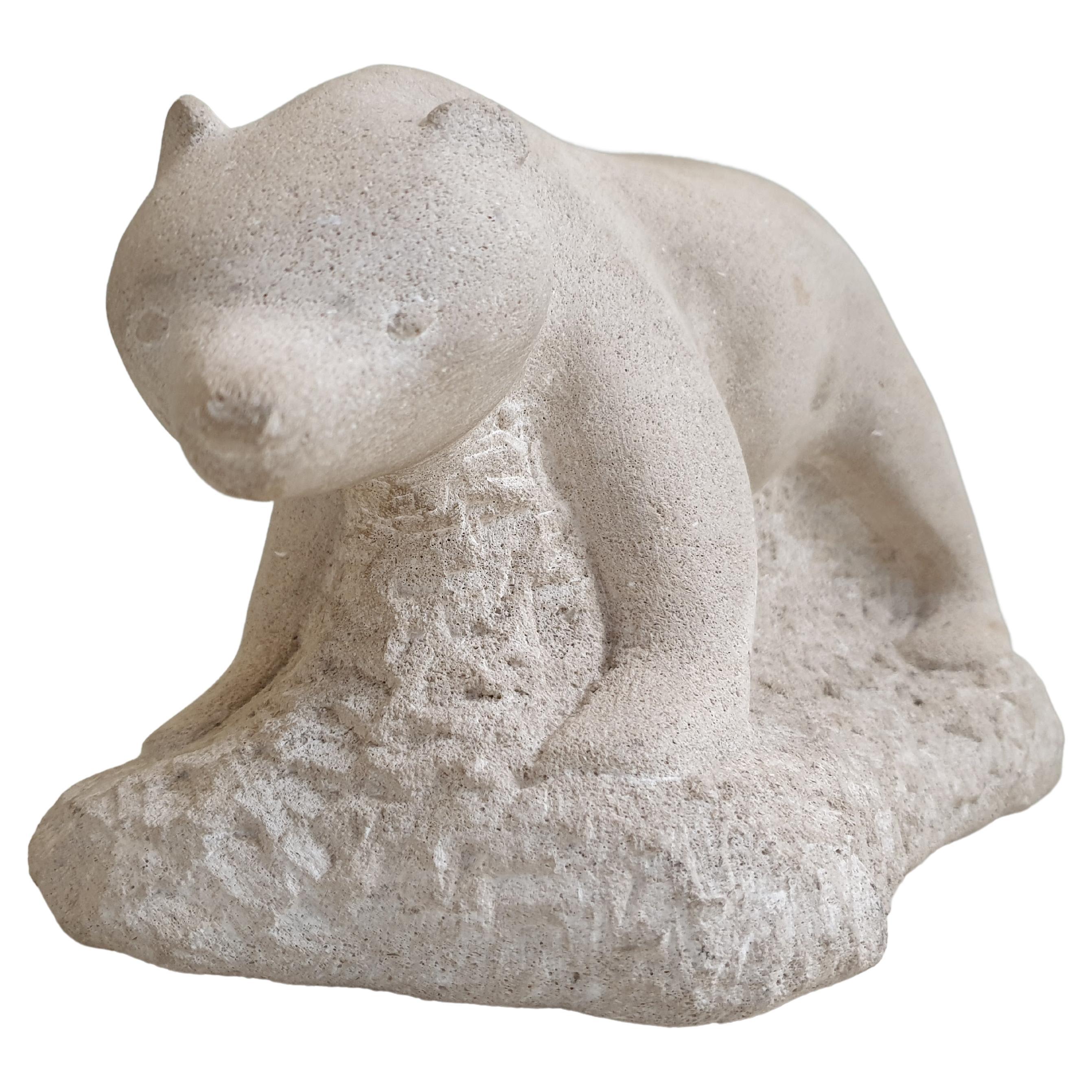 This beautiful polar bear sculpture in stone, has a whimsical quality to it. The bear is carved beautifully and its face has a sweet expression, it is possibly a polar bear cub. It is rare to see an artist, P Klinck, who can successfully represent