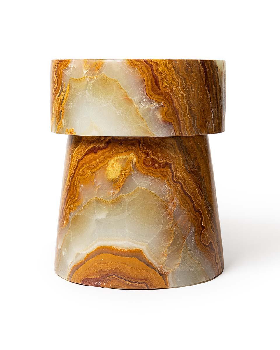 The Carved Stone Stool Series are combinations of either straight or tapered capitals and bases. Shape 3 is the third in the series of 4 shapes, with  a straight capital and tapered base. Shown here in highly variegated Verde Onyx. Each stool is