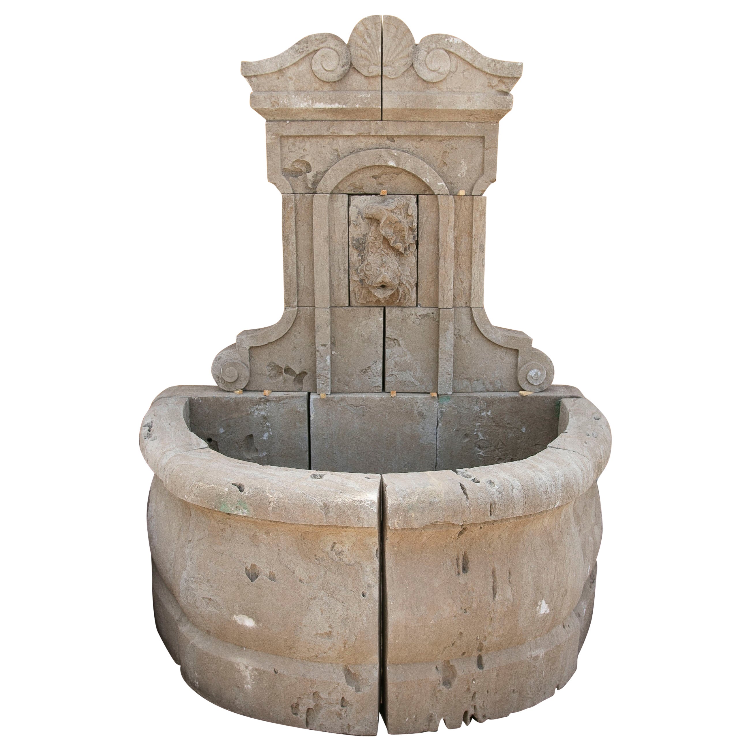 Carved Stone Wall Fountain with a Sculptural Fish and a Semicircular Basin. en venta