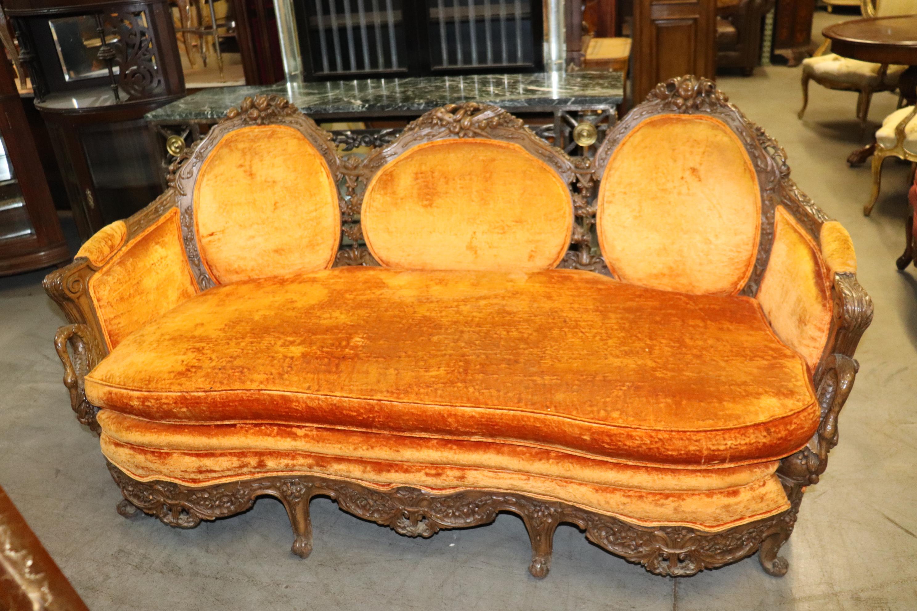 This is a gorgeous and unique swan carved French Louis XV sofa with its good clean original orange velvet upholstery. The carving is very nice and the swans add a touch of charm and class. The sofa measures 74 inches wide x 37 tall x 37 deep and the