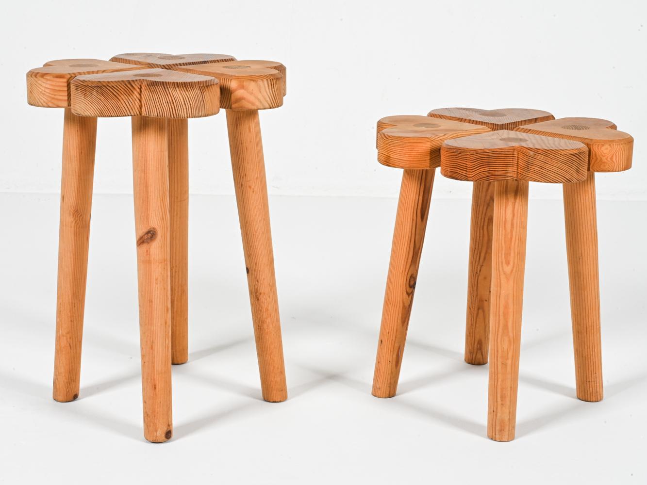 This captivating pair of stools, hand-carved from pine in Sweden during the 1970s, exudes both charm and functionality. The stools feature a whimsical design, each one crafted in the shape of four conjoined hearts, with the complete image giving the