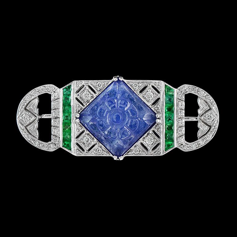 Carved Tanzanite Emerald Diamond 18K W/G Brooch
A masterpiece for your decoration is crafted in 18K White Gold.
The design is special for unique Carved Tanzanite (8.93 ct.) 
Surrounding with Round Diamond 0.4 ct. and Fine Cut Emerald 0.45 ct.
All
