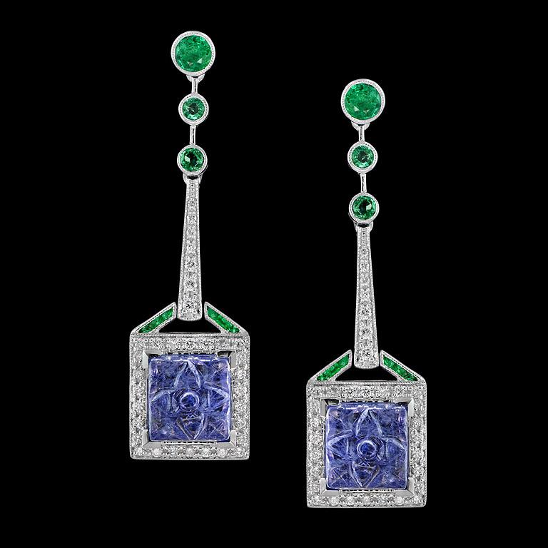 Finely earrings were made in 18K white gold with Tanzanite, Emerald and Diamond in Art Deco Era.
One pair of carved Tanzanite is unique in square shape 9.0 mm. 3.2 carat.
2 sizes of Emerald on top (Round 4.0 mm. and 2.5 mm) 6 pcs. 0.77 carat.
Recut