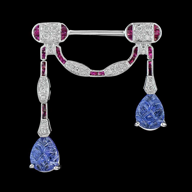 Carved Tanzanite Ruby Diamond 18K W/G Brooch
Art Deco Style Brooch is crafted in 18K White Gold. The design is special for unique Carved Tanzanite (2 pcs. 4.68 ct.) Surrounding with Round Diamond 0.37 ct. and Fine Cut Ruby 0.75 ct.
All stones are