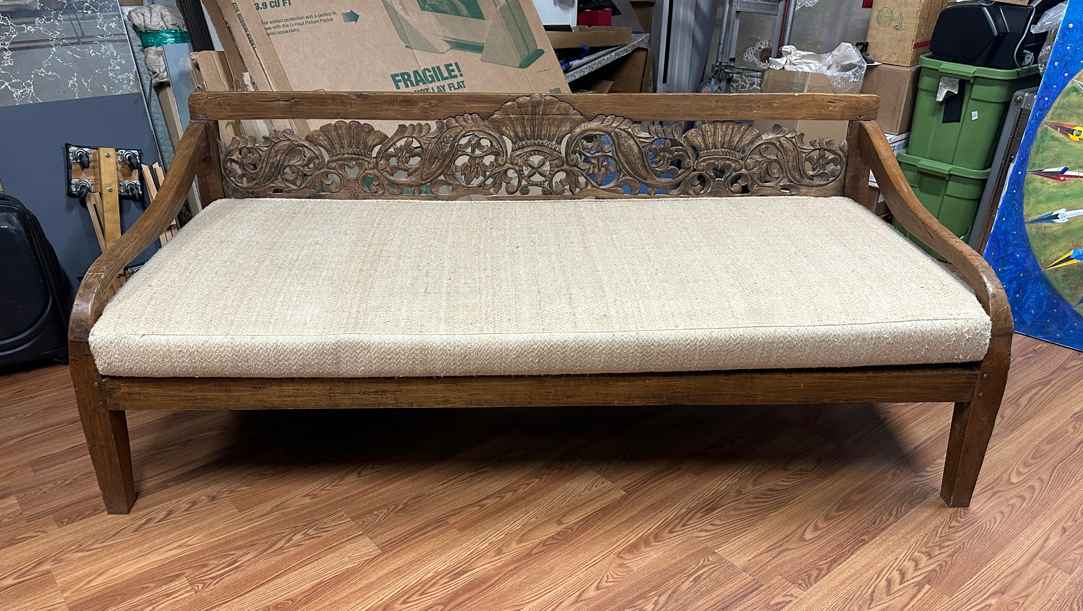 A lovely carved teak daybed sofa likely Indonesian or Balinese. Nice old teak likely antique reclaimed wood. We just acquired it out of a magnificent Palm Springs estate along with some beautiful custom pieces and Michael Taylor and Rose Tarlow