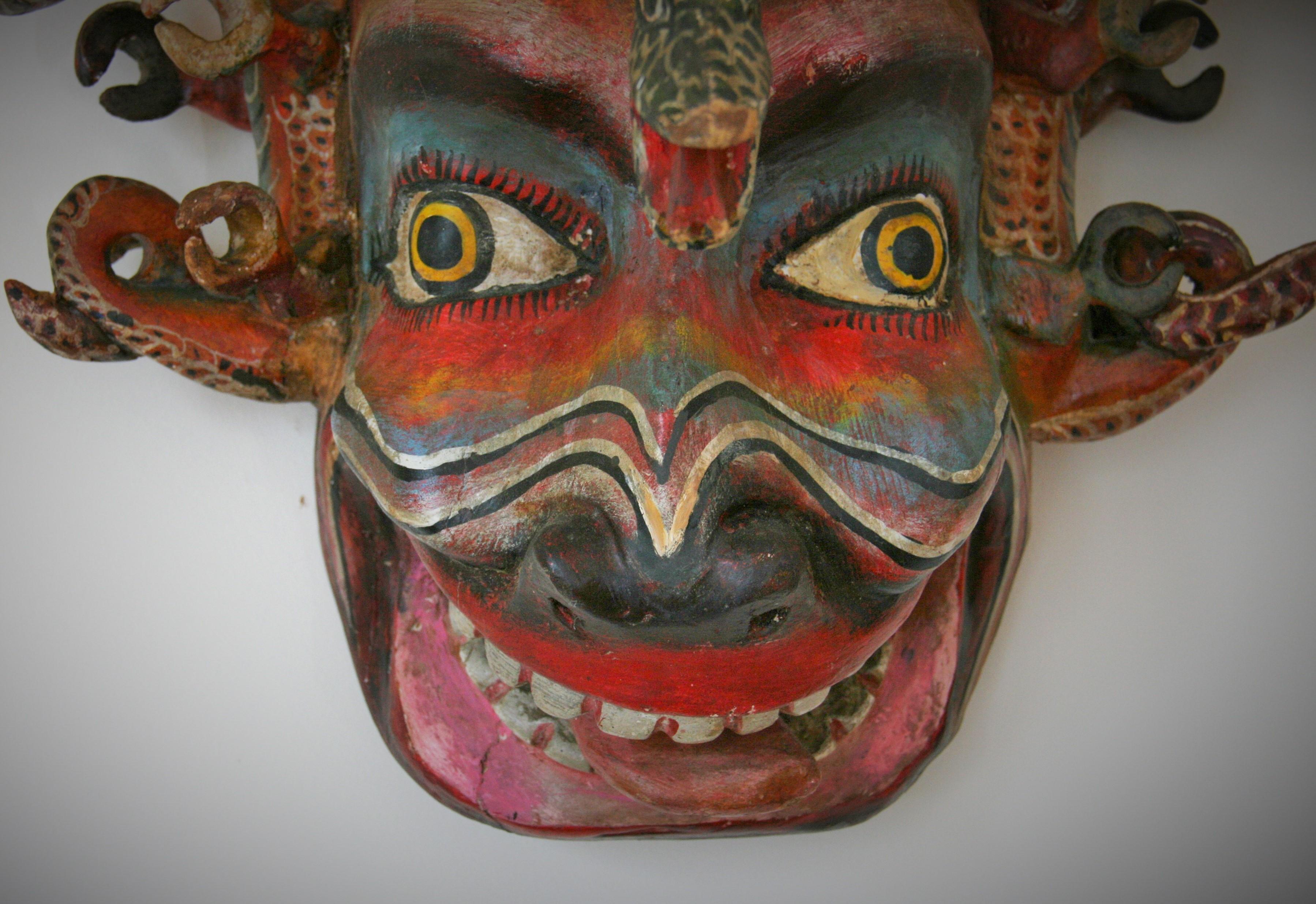 8-195 Intricately carved and painted wood mask of an ornate mythological creature mask with elaborate 3D carving.