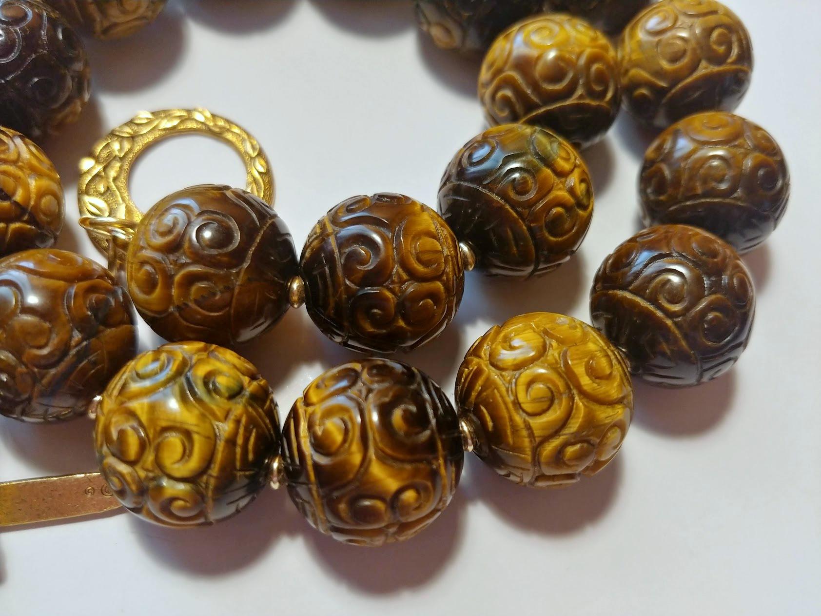 The length of the necklace is 23.5 inches (60 cm). The size of the carved round beads is 18 mm. The tiger's eye beads are old.
The tones of the beads are a wondrous golden brown, caramel gold, and silky—gorgeous warm shades.
The color is authentic