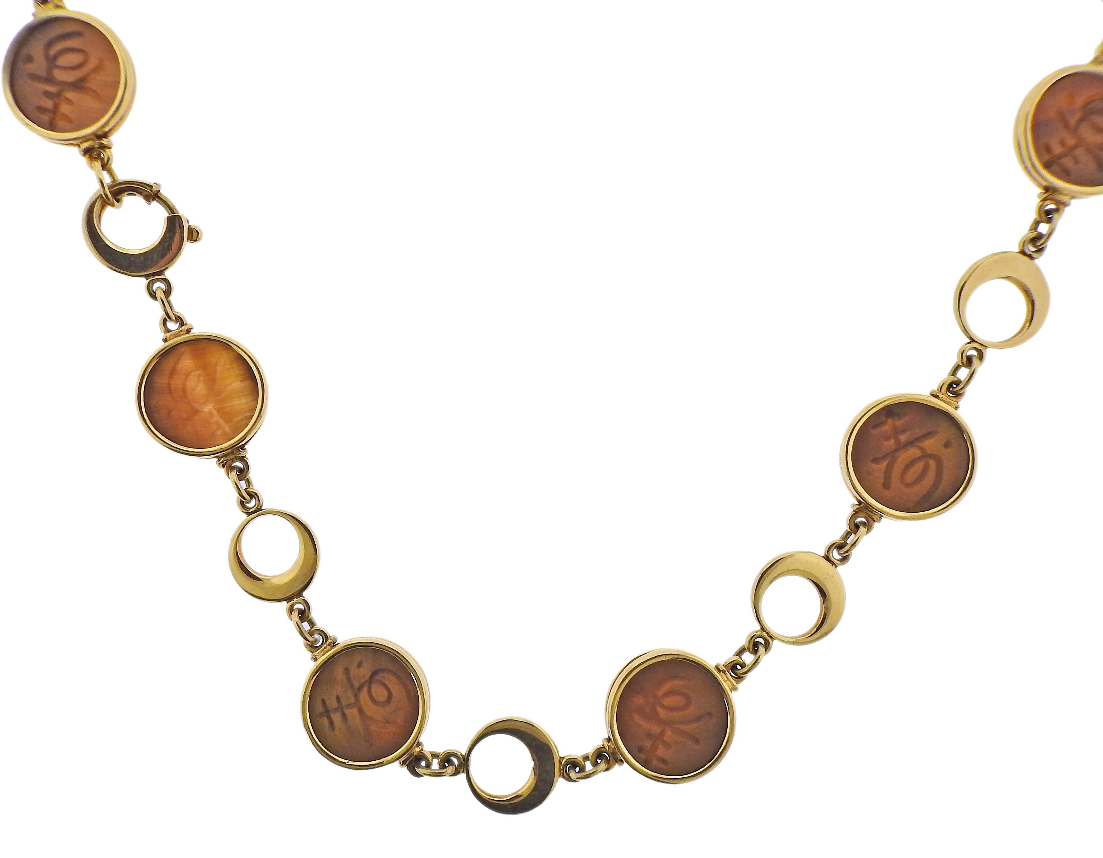 18k yellow gold circle link necklace with carved tiger's eye. Necklace is 34
