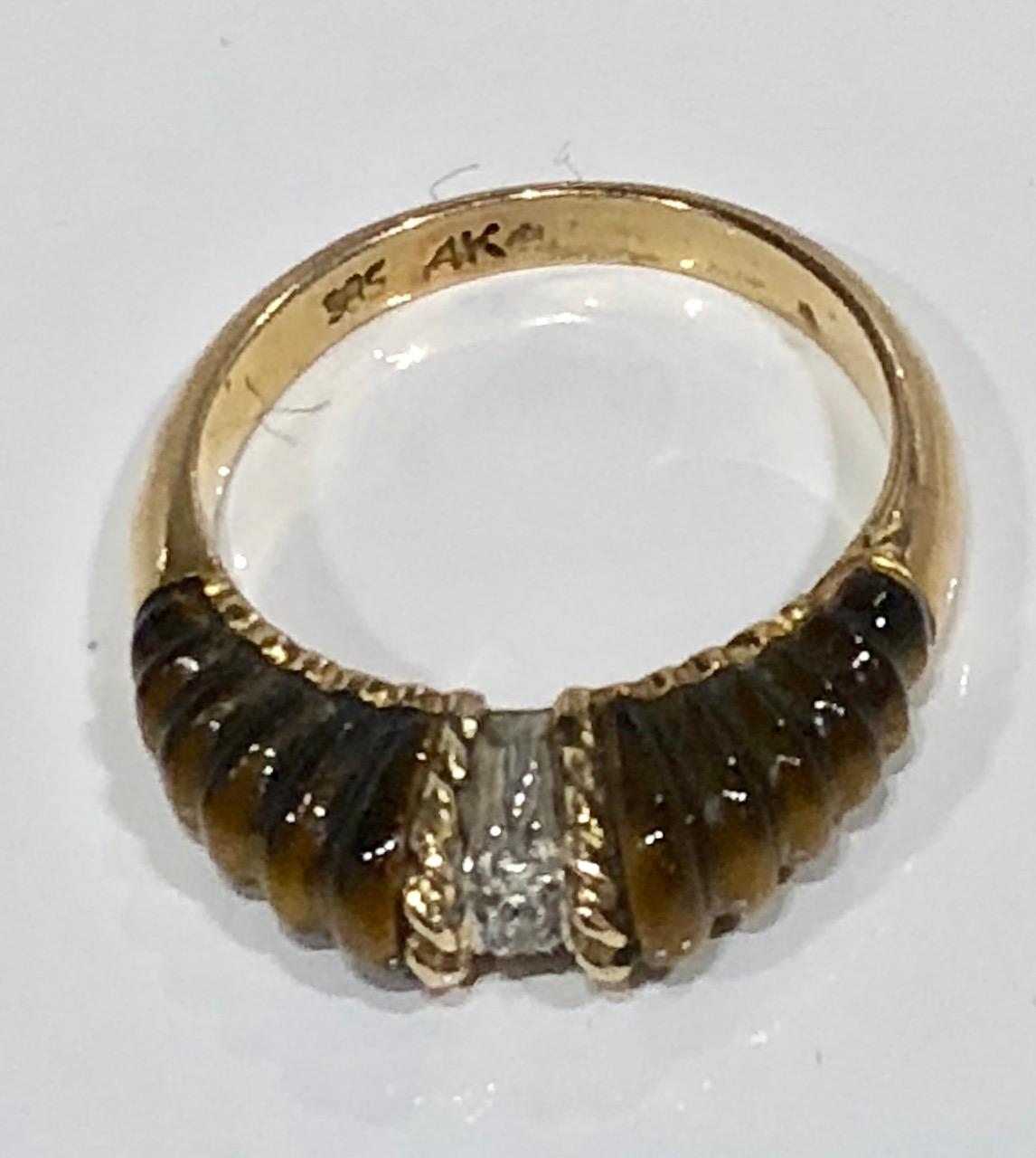Carved Tigers Eye with diamond inset ring in 14k gold. Ca 1970's
Stamped. Size 7 US
