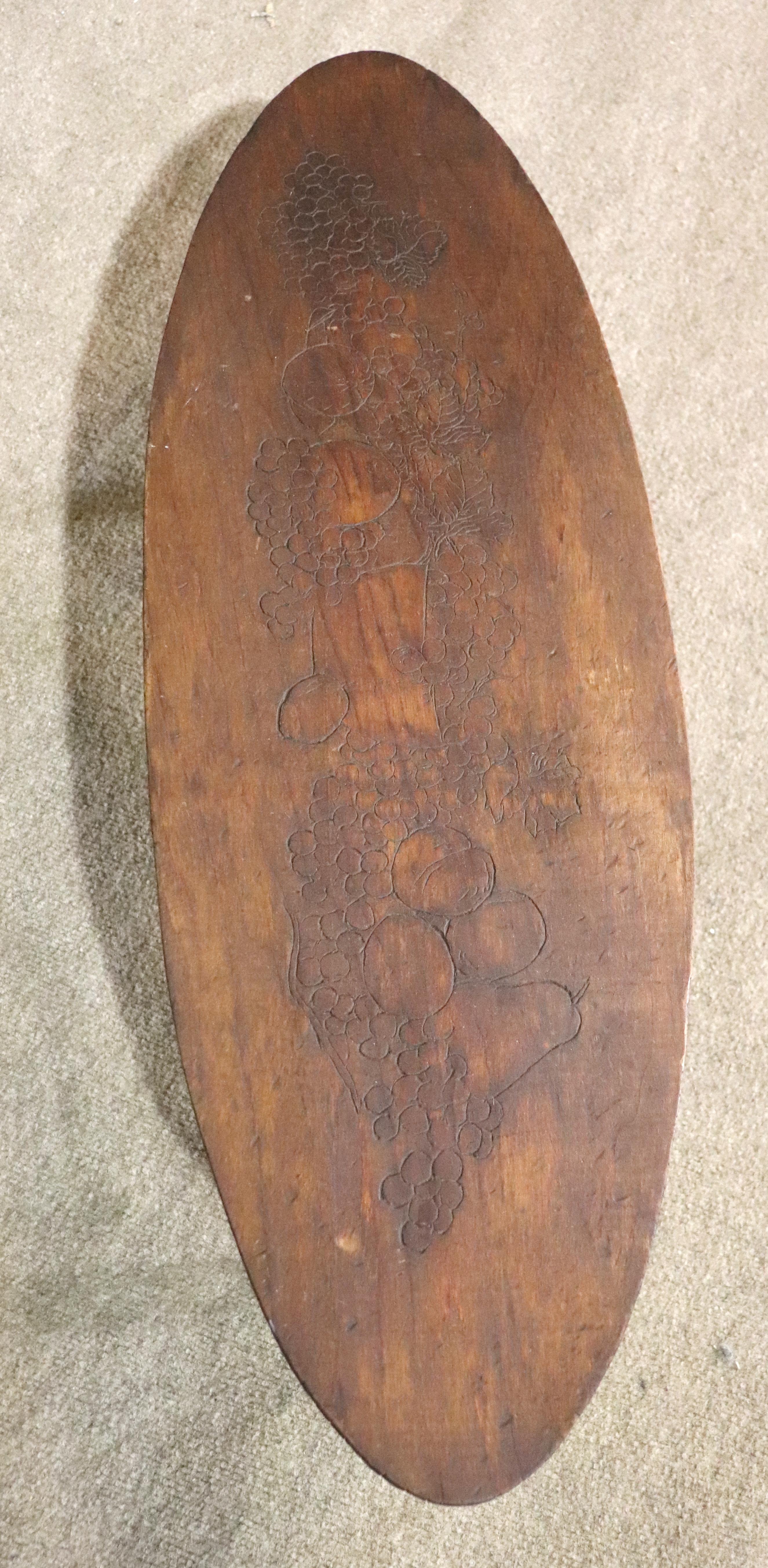 Vintage coffee table made of a single slab that has a still life of fruits carved into the top. Set on tapered brass tip legs.
Please confirm location NY or NJ