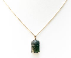Carved Tourmaline Buddha Pendant Set in 18 Karat Gold Settings