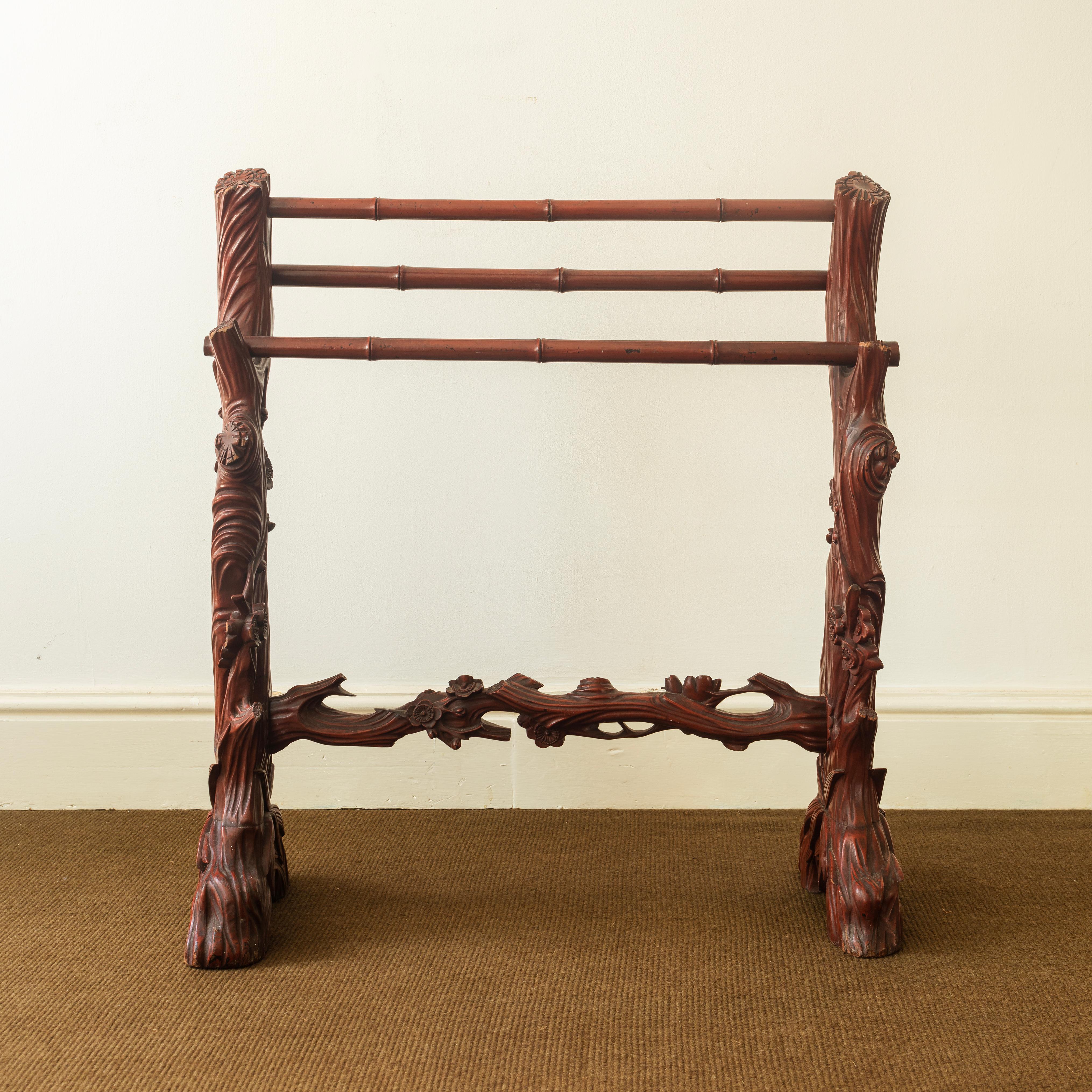 A towel or clothes rail presumably made for a Chinoiserie bathroom, the rails carved to simulate bamboo, the ends with flowering prunus and bark. An unusual, decorative and useful piece of furniture.
English 1920s 

Size: 85 x 80 cms