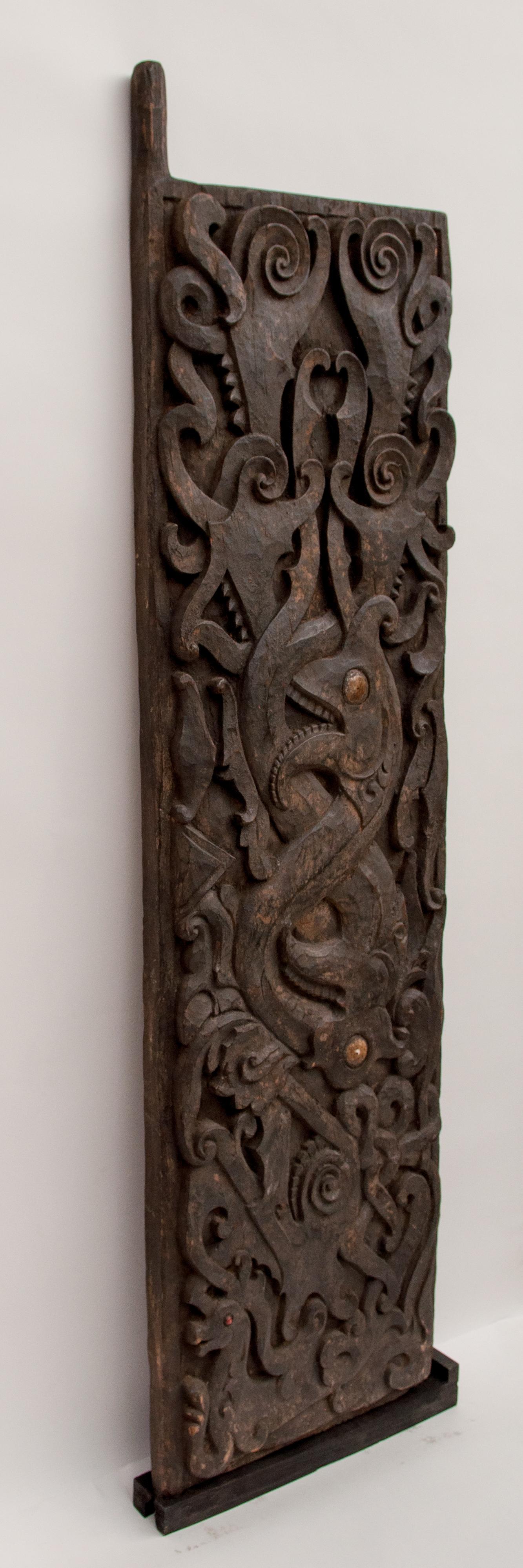 Carved tribal door panel, Aso motif. Dayak of Borneo, Indonesia, early to mid-20th century.
Hand-carved of ironwood and dominated by an intertwining Aso Motif, the mythological dragon dog and supernatural guardian which plays such a central role in