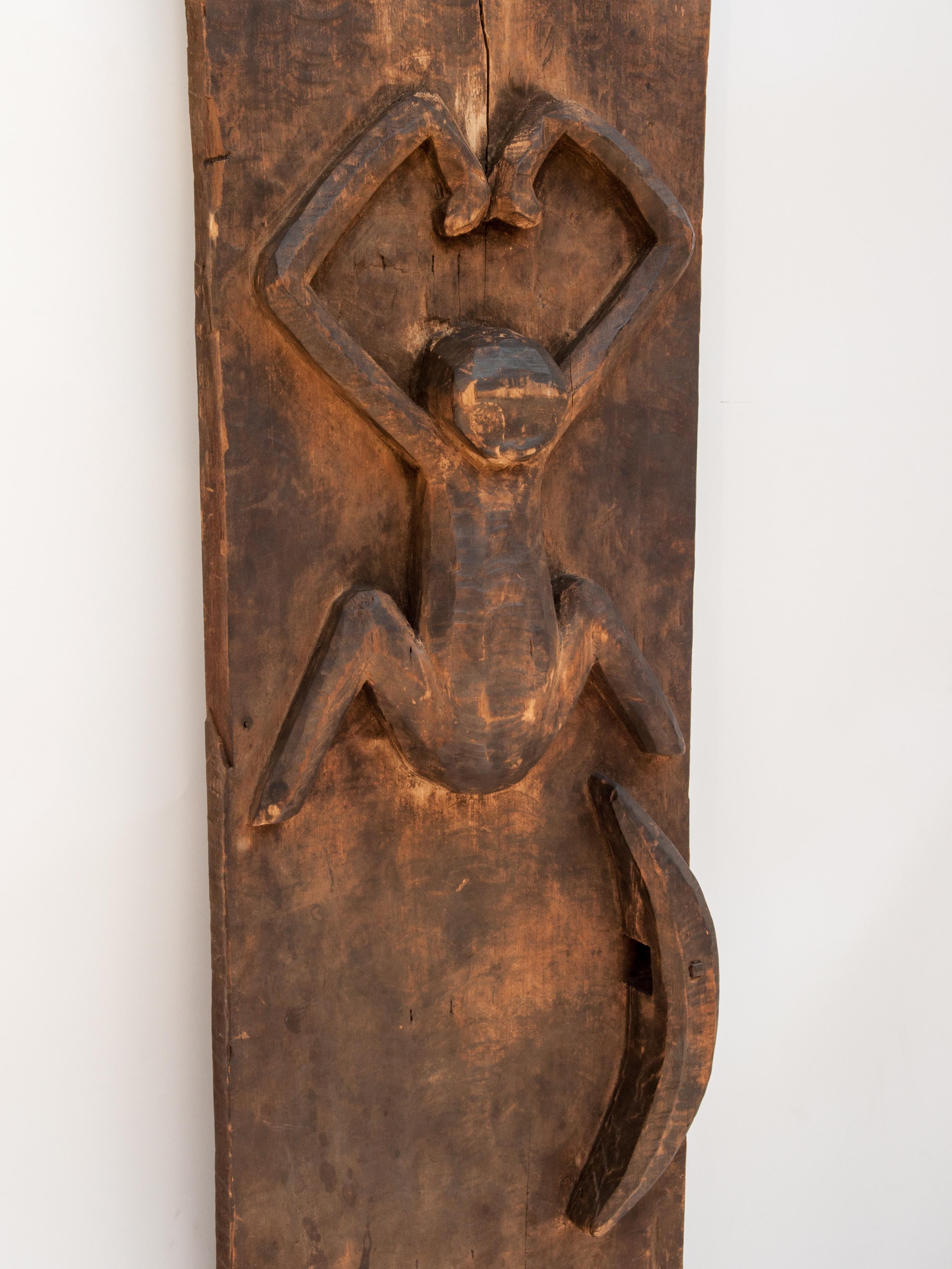 Carved tribal door panel, gibbon motif. From the Mentawai Islands, Indonesia, mid-20th century.
The Bilou gibbon is an centrally important motif often encountered in Mentawai art, and is here depicted in a typically graceful and symmetrical manner.