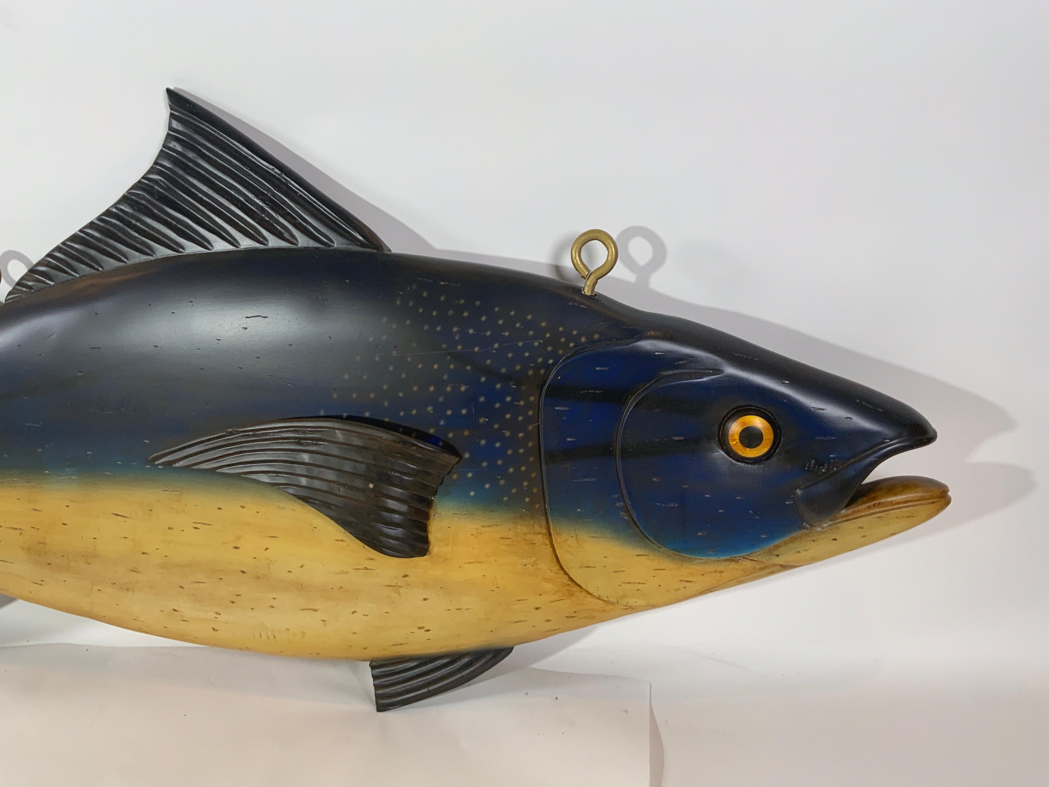 Carved and painted Atlantic Bluefin tuna. Carved fins, gills, eyes and snout. Fitted with iron hanging bolts. This carved fish is reminiscent of the trade signs that would hang in the fishmongers stalls at the Dover Fish Markets in