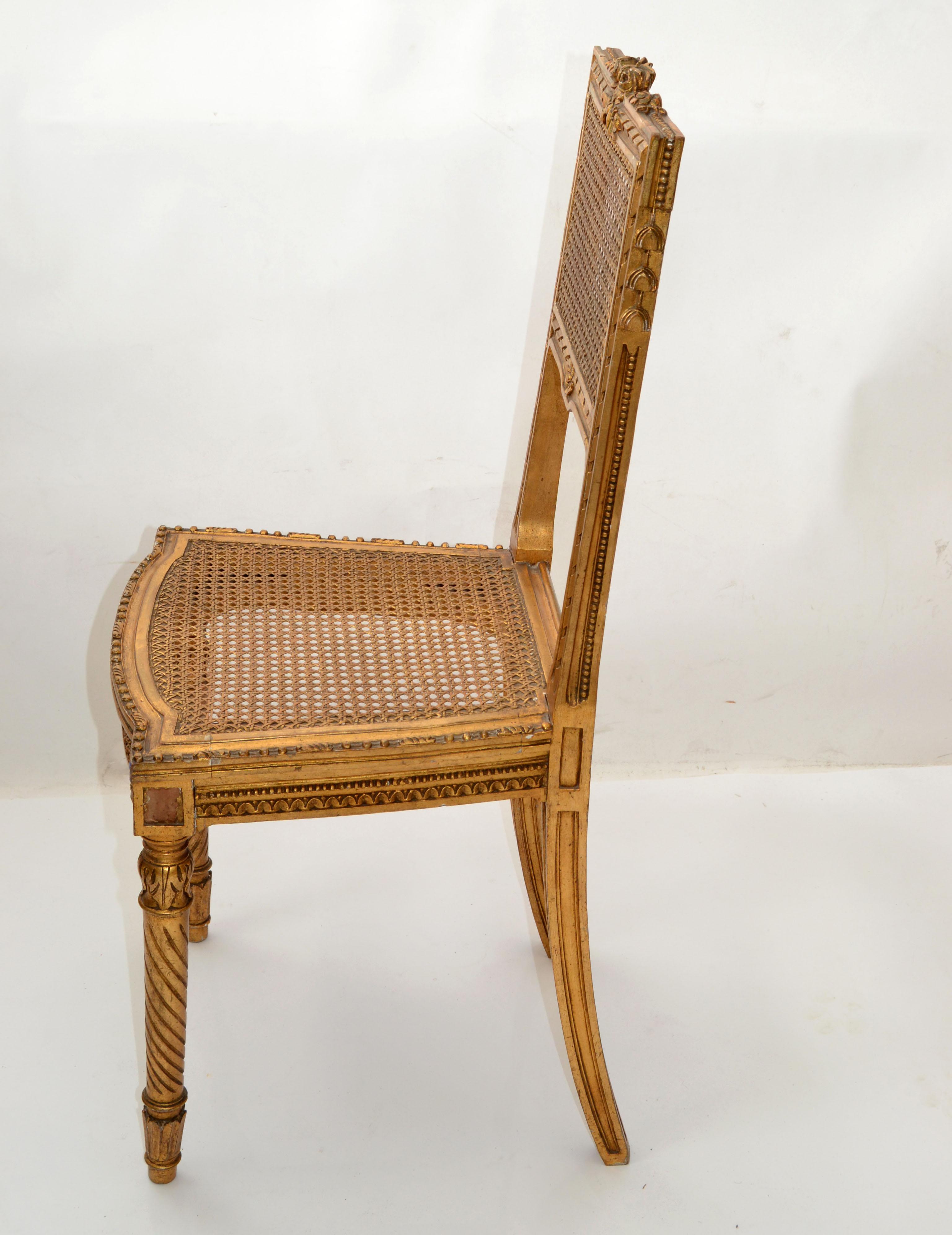 We offer a hand-carved and hand-woven Vanity chair, side chair in gilt wood with turned front legs and carved back legs, handwoven cane seat, backrest and Roses, Ribbon carvings.
Ready to use with some wear to the gilt paint due to History.
  
