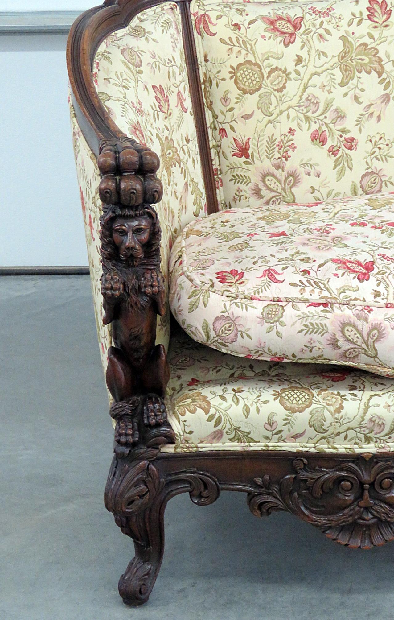 This is a wonderful sofa. The carved walnut lion frame is quite rare and hard to find. This American-made antique dates to the 1920s era and is of the highest quality in terms of carving and detail. The upholstery is a second recovering and is a