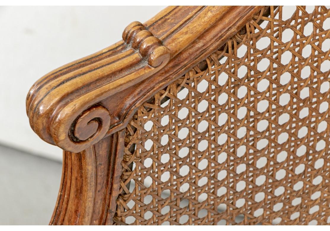 Signed Tardif Paris. Lovely Louis XVI style carved tub chairs with caned backs and seats. Ribbed frames with scrolled arm ends and carved acanthus leaves on the supports. With a shaped front skirt, raised on all fluted tapering cylindrical legs with