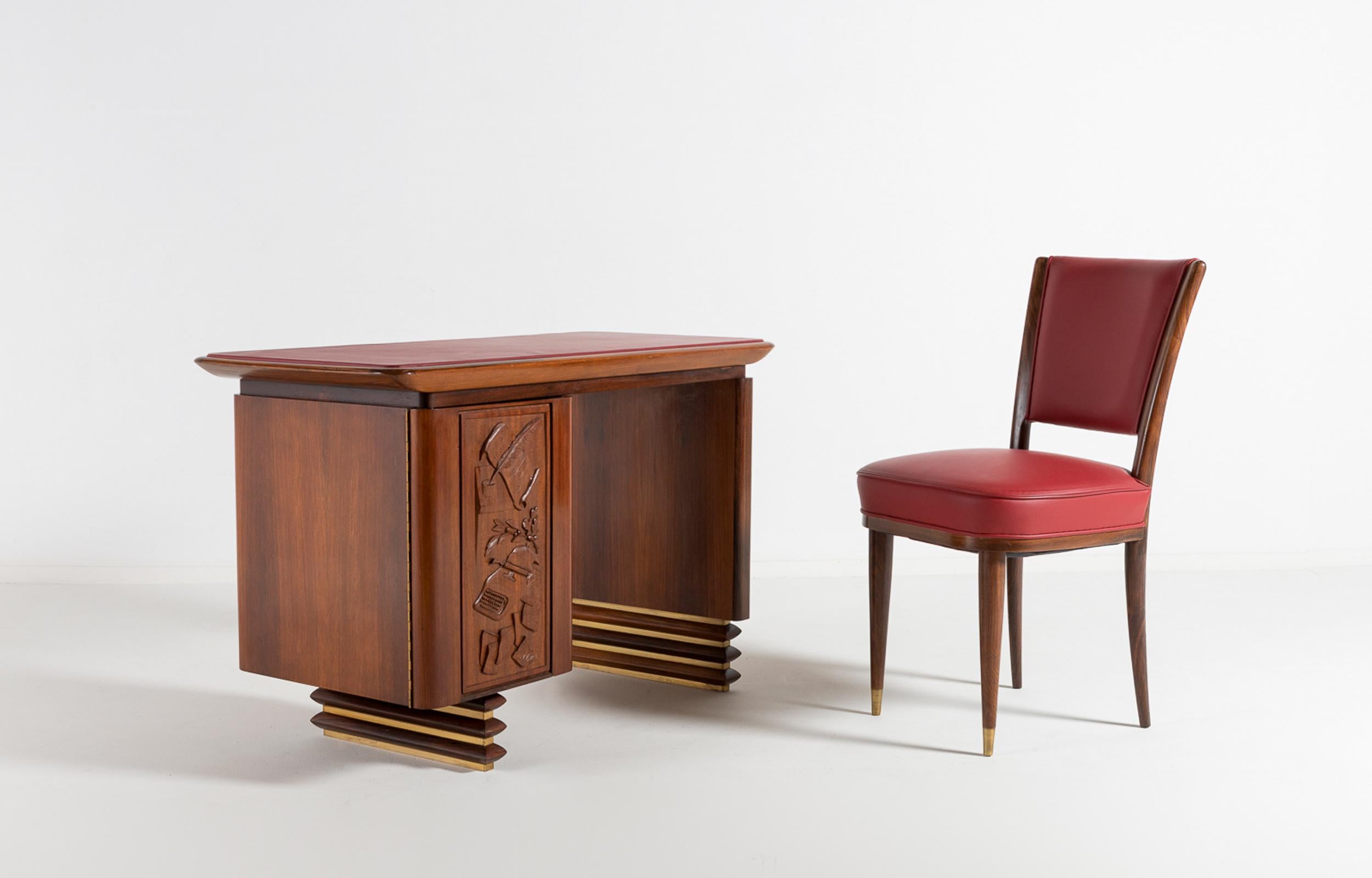 A superb Italian walnut and rosewood desk with matching rosewood and leather side chair, made to measure for the villa of an Italian executive in 1960. The rectangular top is covered with the original red leather. The front of the hidden drawer unit