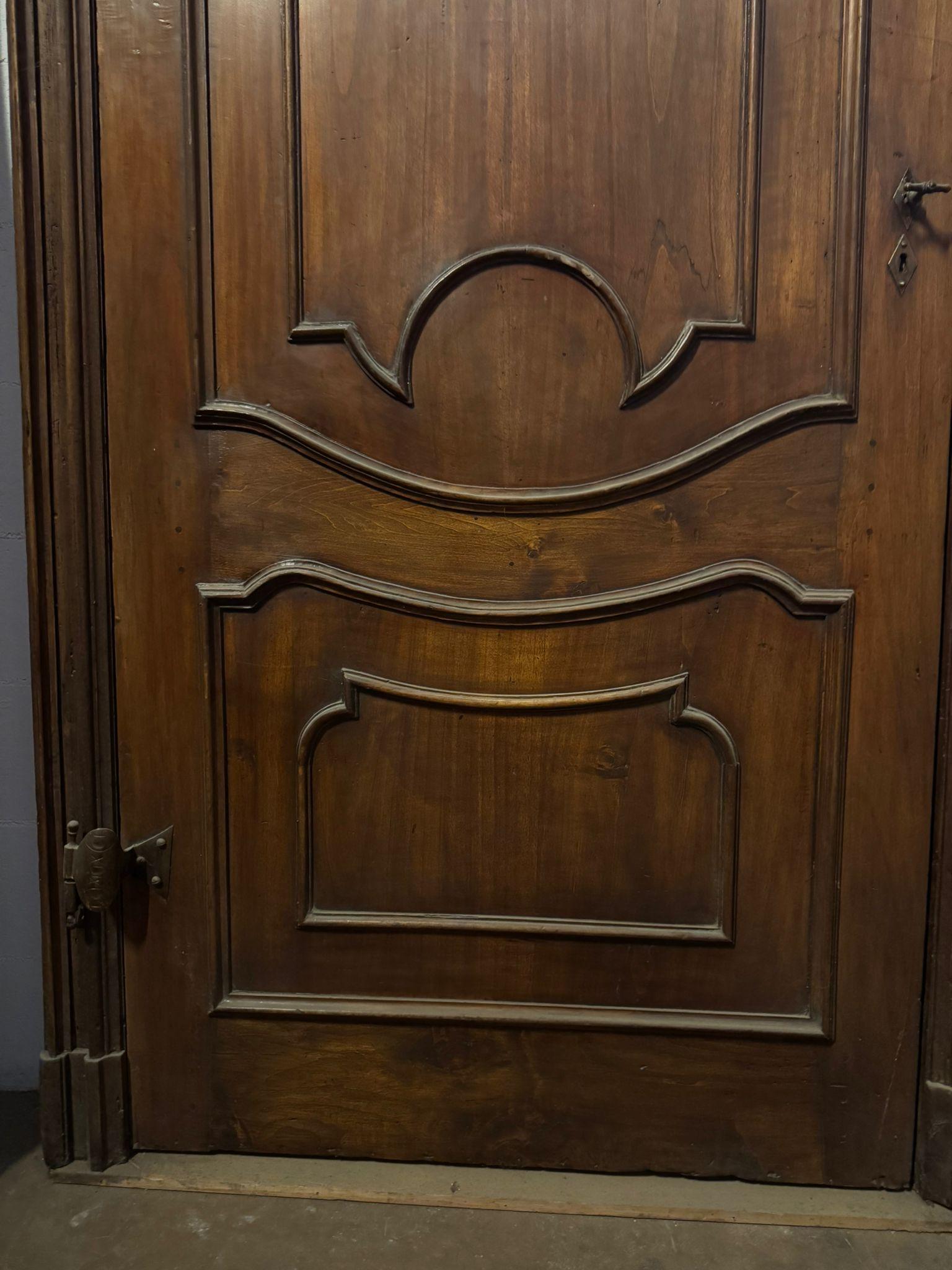 Hand-Carved Carved walnut door with a tall frame and space for an overdoor, Italy For Sale