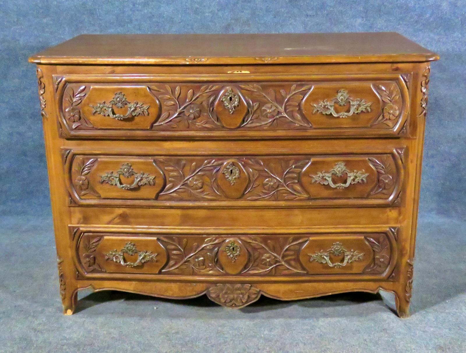 3 drawers. Floral detail in wood. Measures: 33 3/4