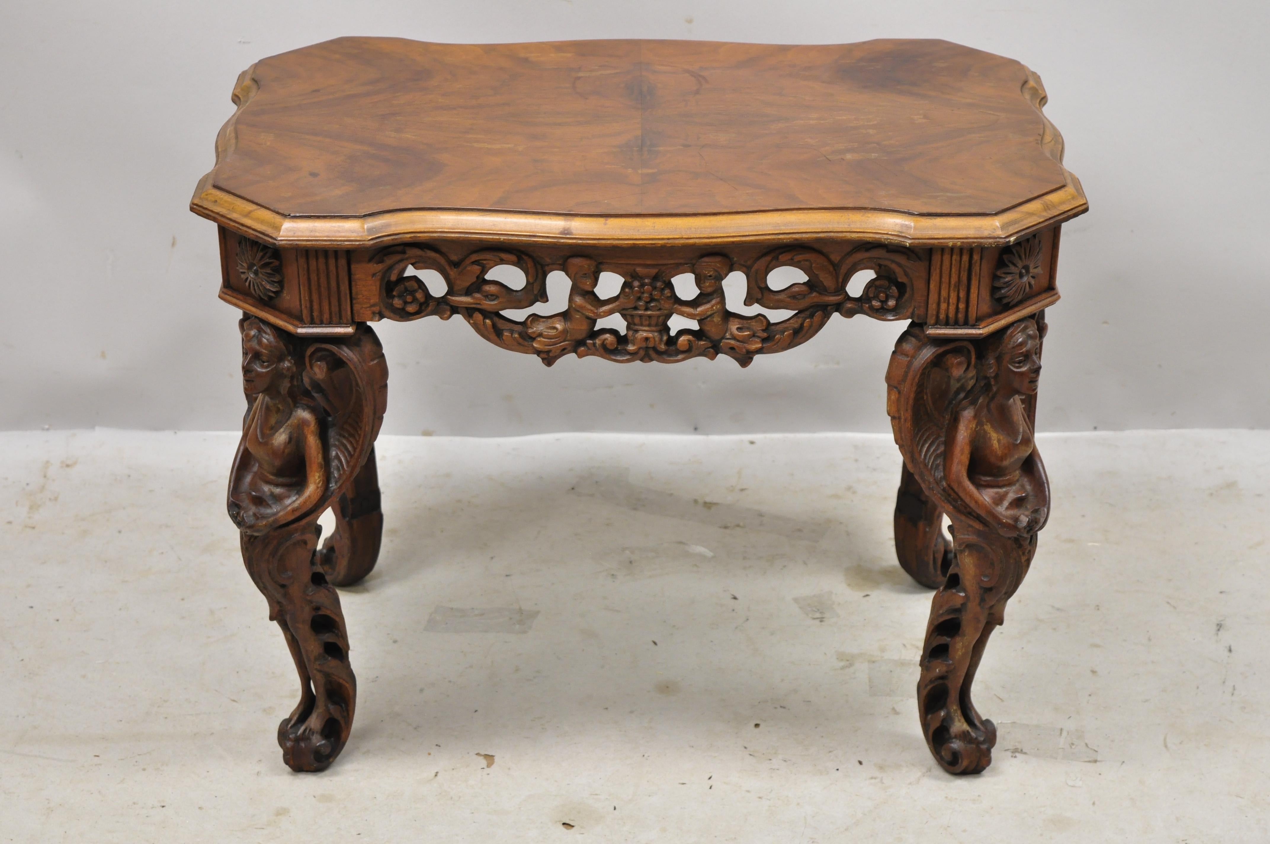 Antique carved walnut French renaissance small figural coffee table with winged maidens. Item features full figured winged maiden legs, shaped top, beautiful wood grain, very nice antique item, great style and form, Circa early to mid-1900s.