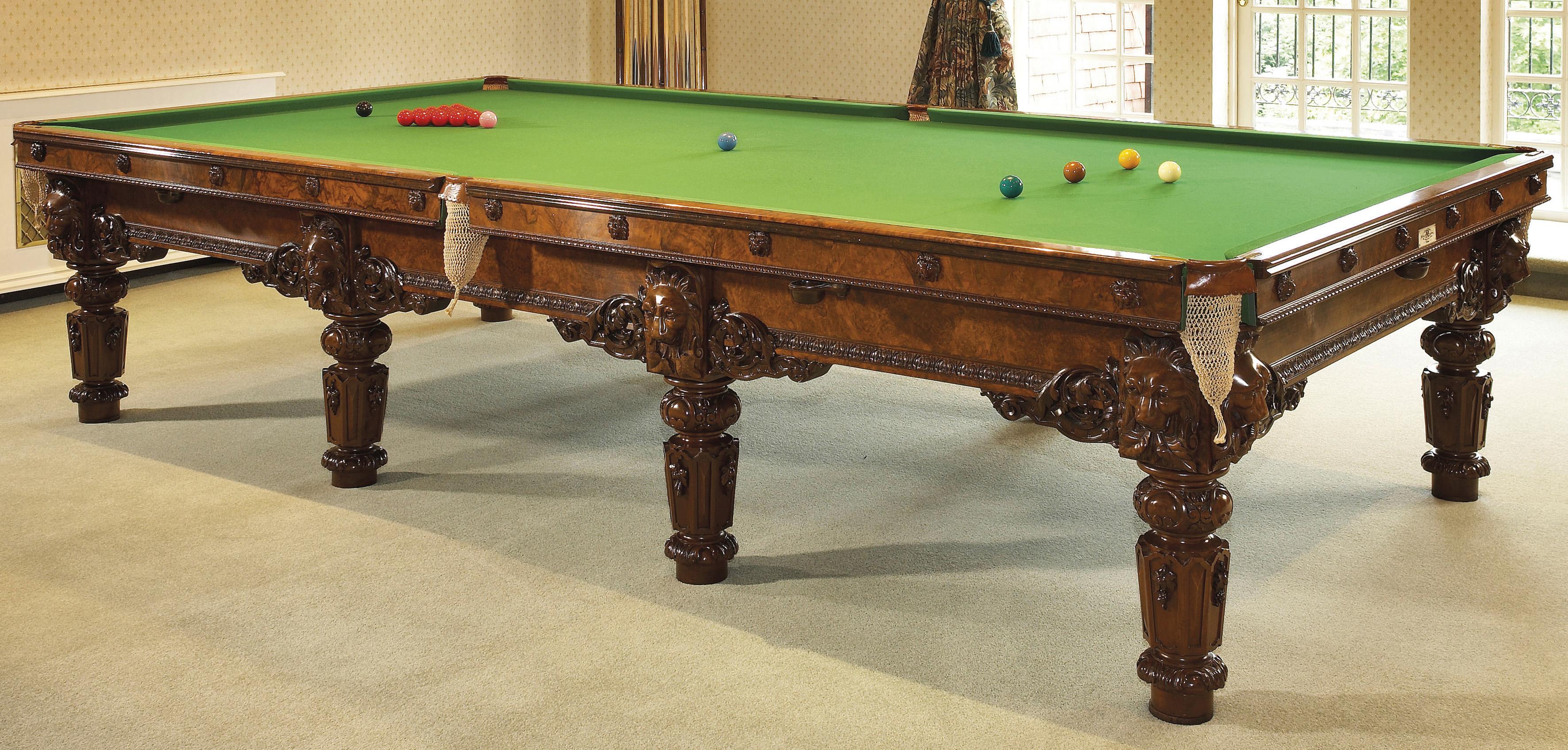 An exceptional carved walnut full size billiard table and accessories by Cox & Yeman.

London, circa 1880. 

One end bearing an ivorine label 'Cox & Yeman / Billiard Table Manufacturers / 184 BROMPTON ROAD, / London'. 

The Billiard table