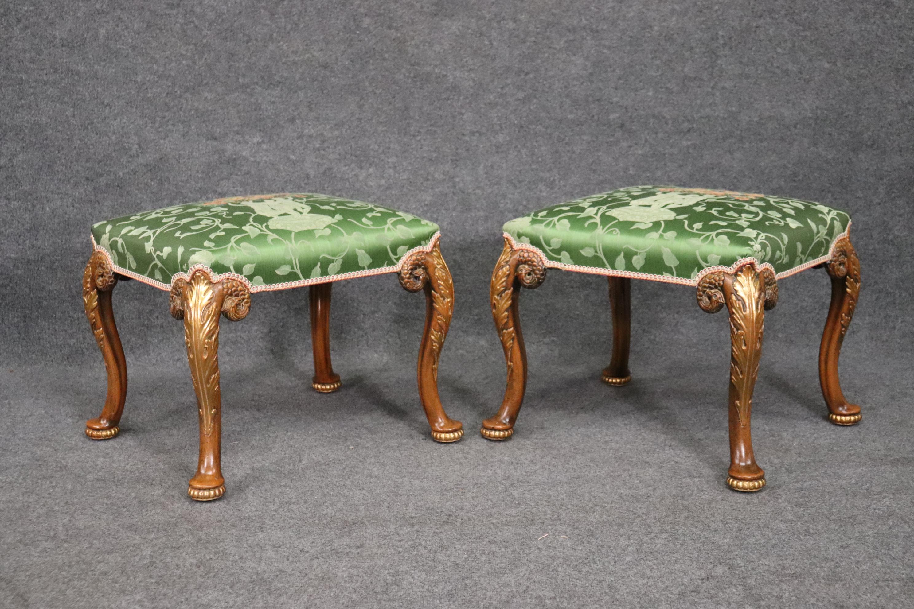 This is a gorgeous, absolutely decadent pair of Georgian style foot stools from the 1920s. The upholstery is in good original condition and probably not original. It appears to be silk and have a figural theme. The stools measure 23 x 19 tall x 20