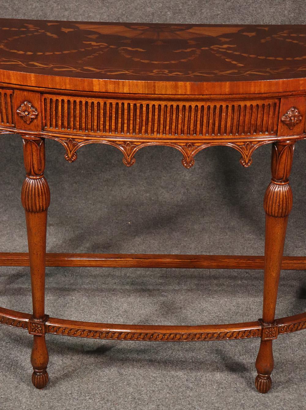 This is a superbly inlaid and finely crafted French style console table with exceptionally well-done inlay and fine lines. The design is beautifully handled. Dates to the 1950s era.

Measures: 46 wide x 32 tall x 16 deep.