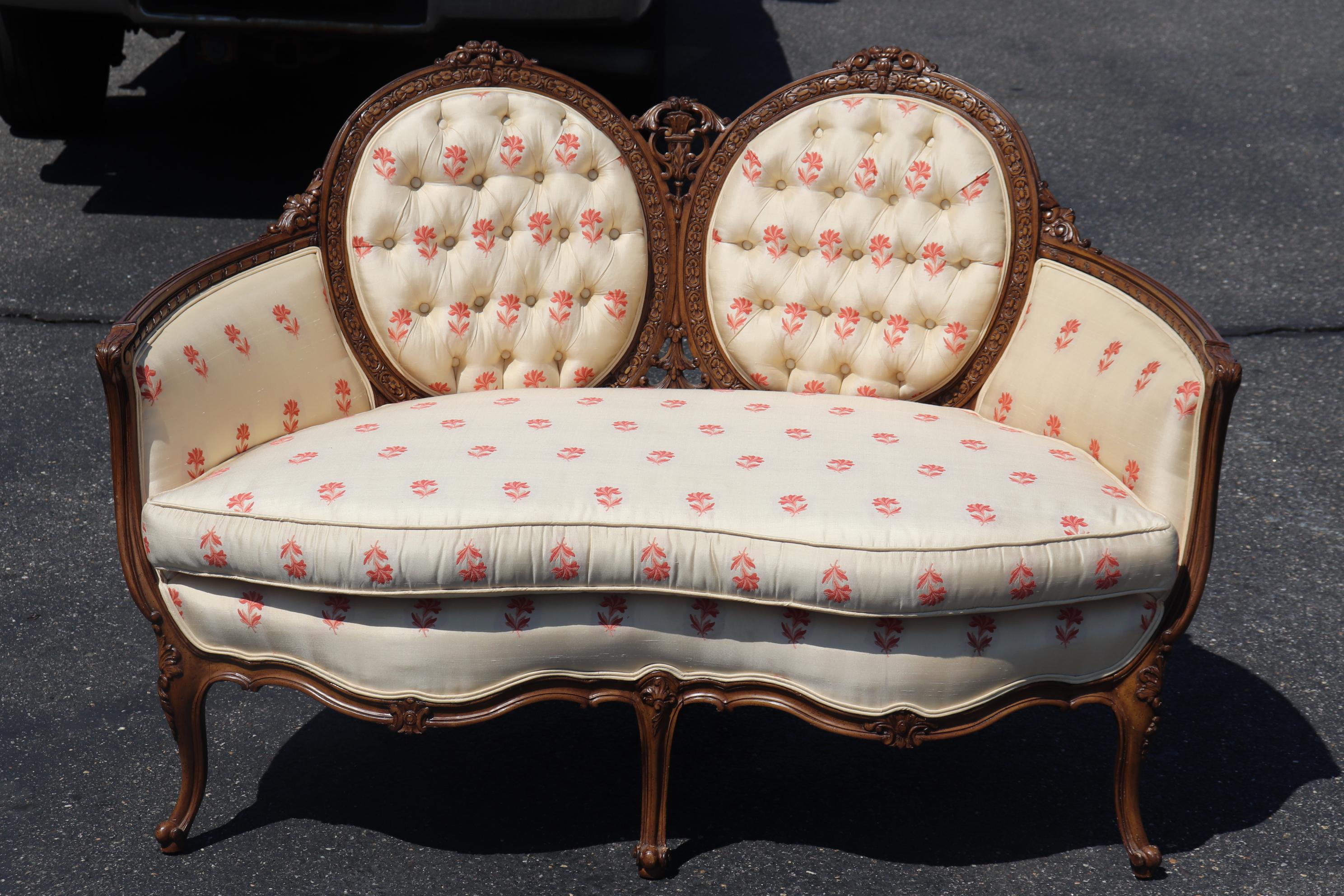 This is a a beautiful form of cameo back Louis XV settee. The upholstery is ok everywhere but the back which is torn. It could be replaced with a similar or contrasting material. The settee is in otherwise good condition and measures 54 wide x 32