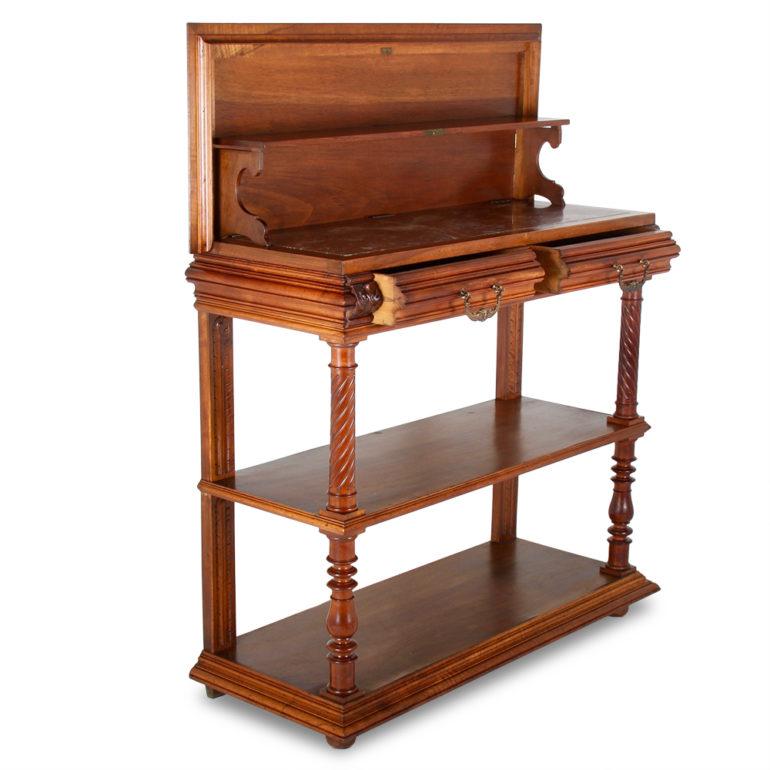 A French Henri II-style walnut server. The top opens to reveal a marble surface with a raised backing, with a lower shelf for storage below the marble top and two drawers for additional storage. Lovely hand carving throughout with brass highlights.