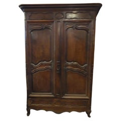 Carved walnut wardrobe with two doors and a drawer, France