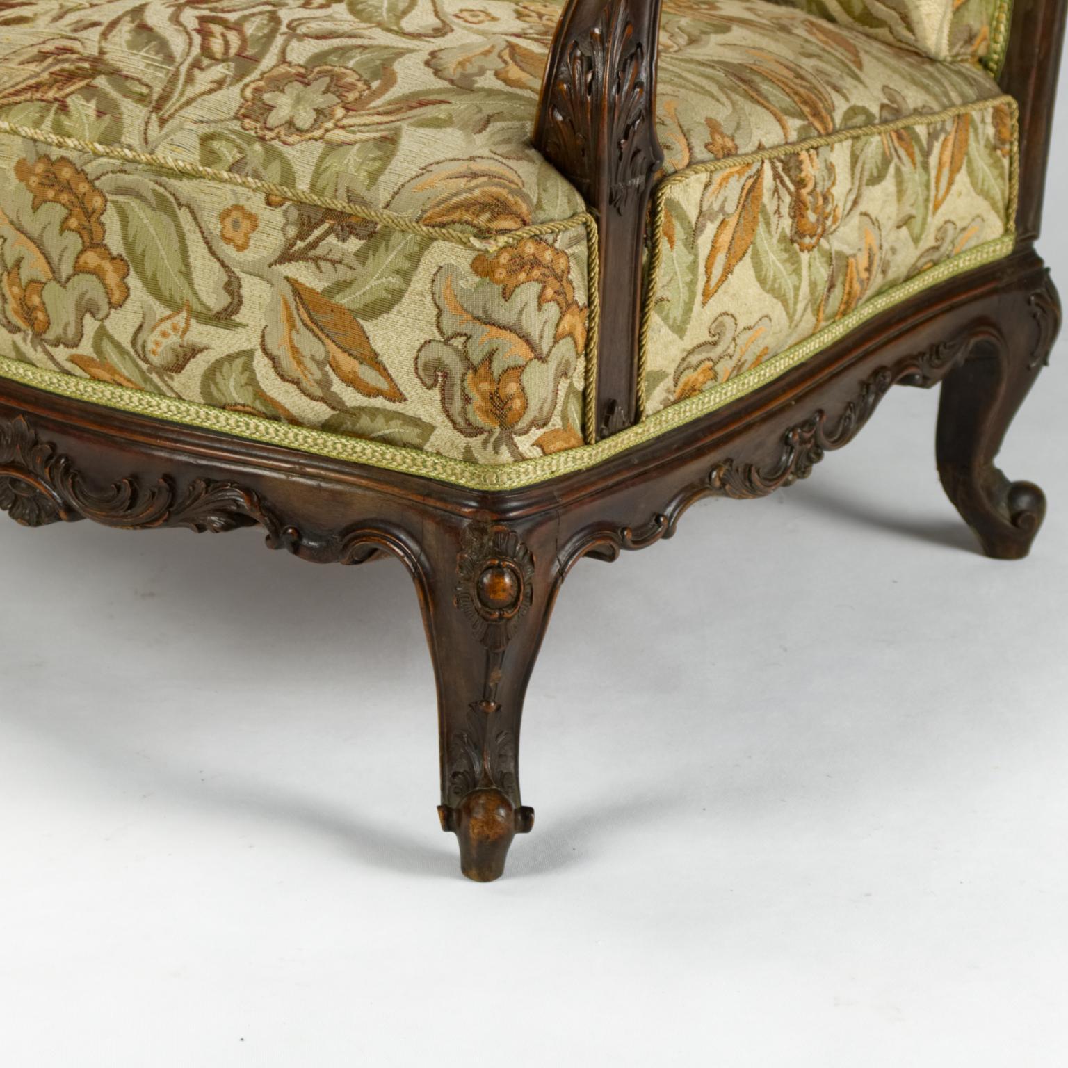 19th century Austro-Hungarian Louis XV style hand carved walnut bergère armchair in original condition, original upholstery, and wing back.