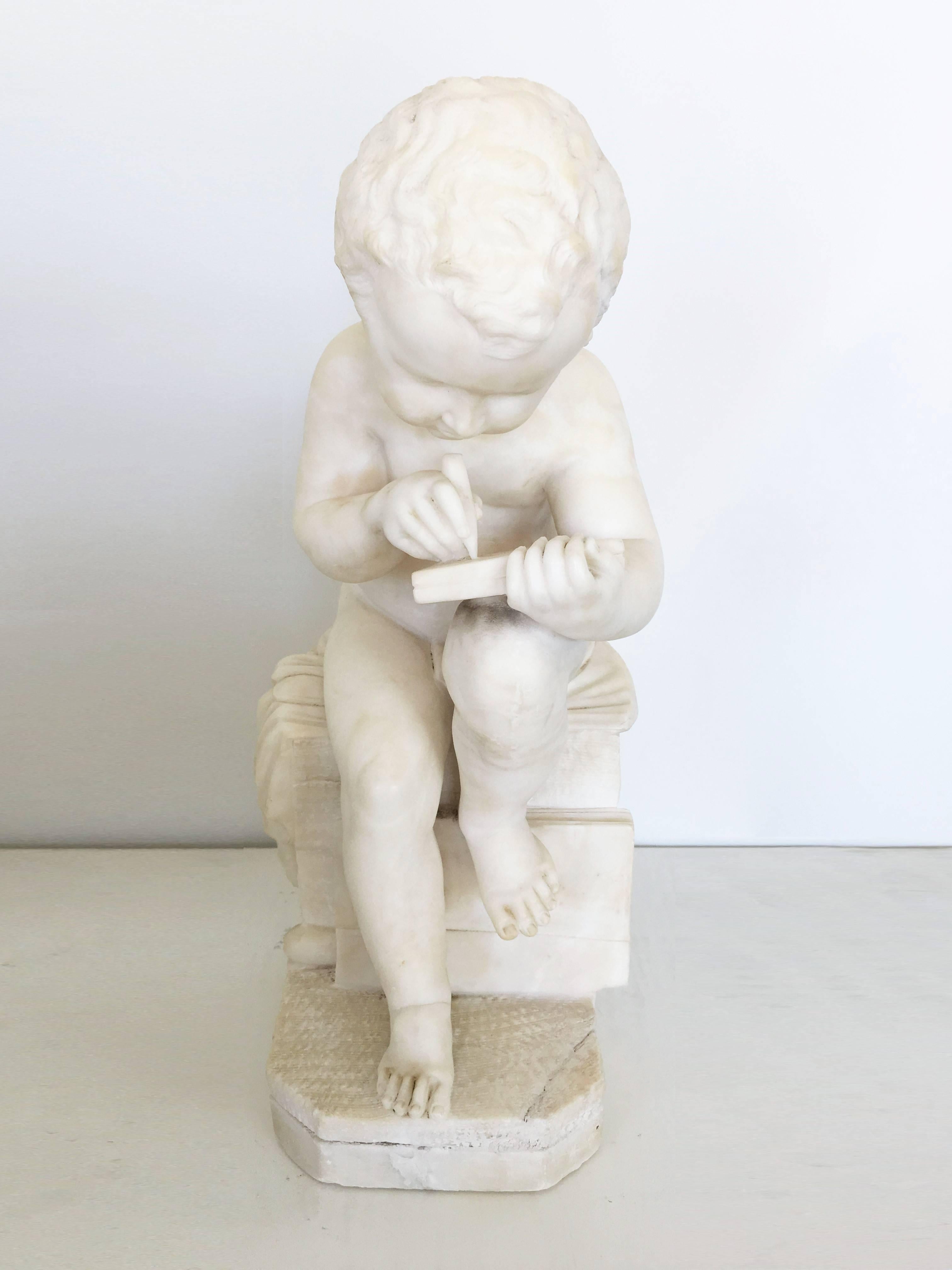 French Carved White Marble Sculpture of a Child Writing For Sale