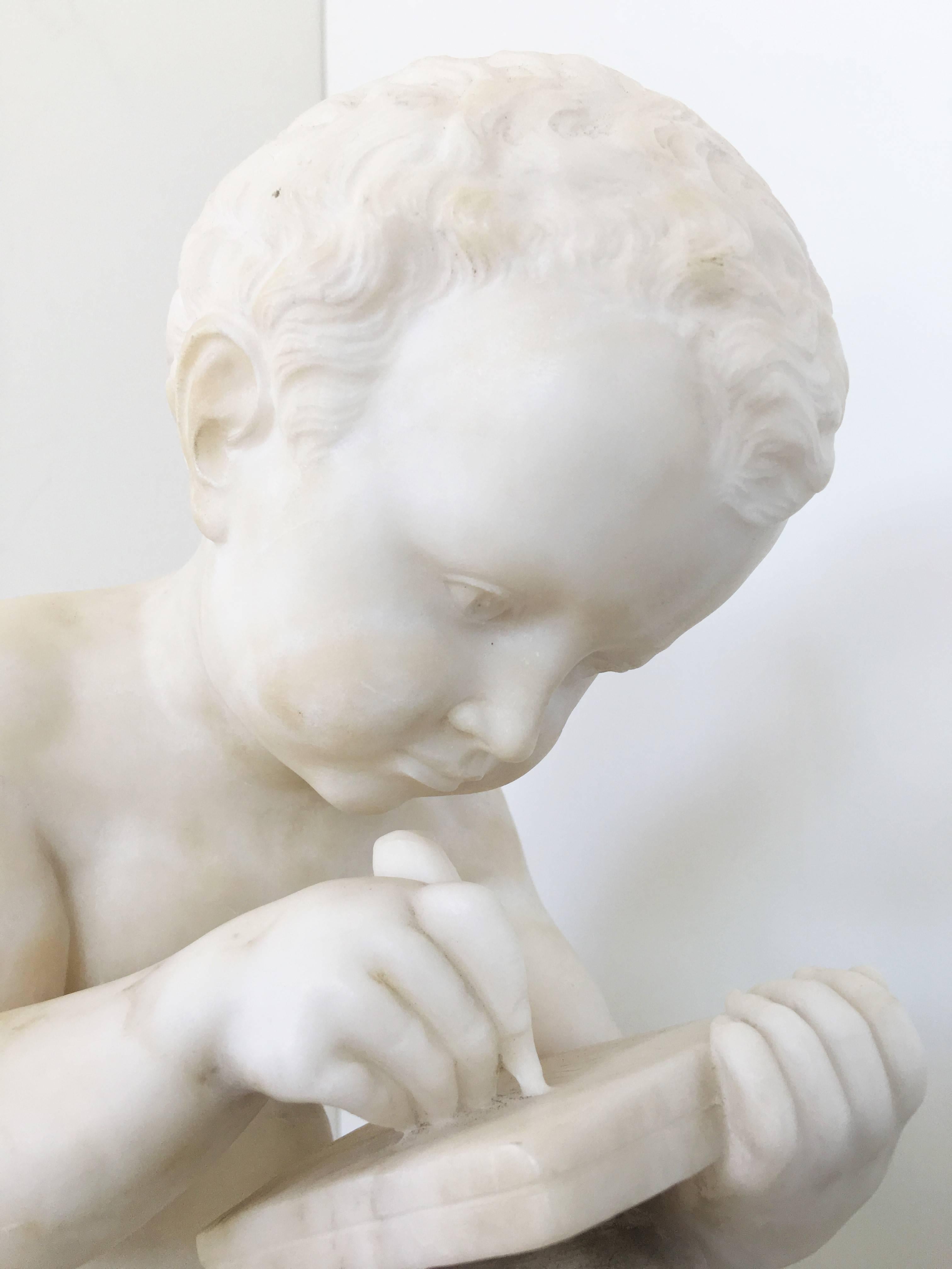 Carved White Marble Sculpture of a Child Writing For Sale 2