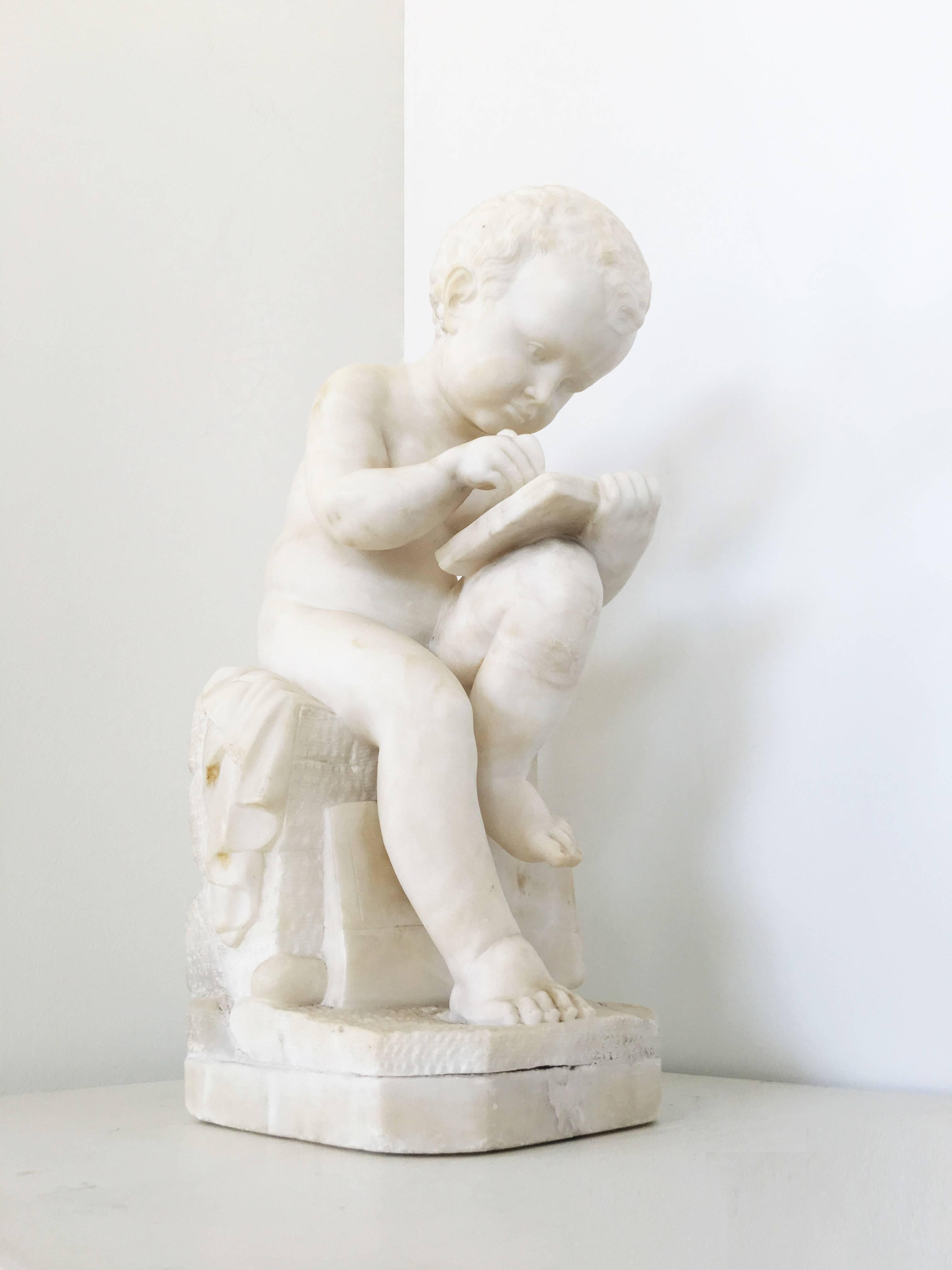 Carved White Marble Sculpture of a Child Writing For Sale 3