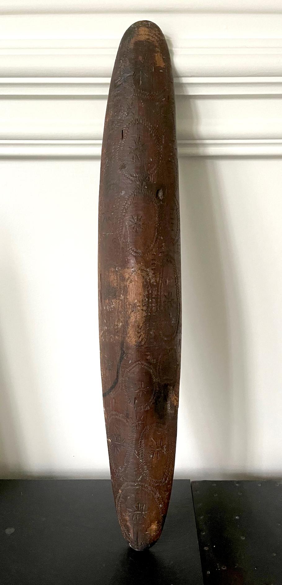 A tall and narrow parrying shield from the Aboriginal people living in the Western Australia. The piece was carved out of a single block of hard wood that is dense and heavy. Of a classic and distinguish spindle shape, a swell middle part integrates