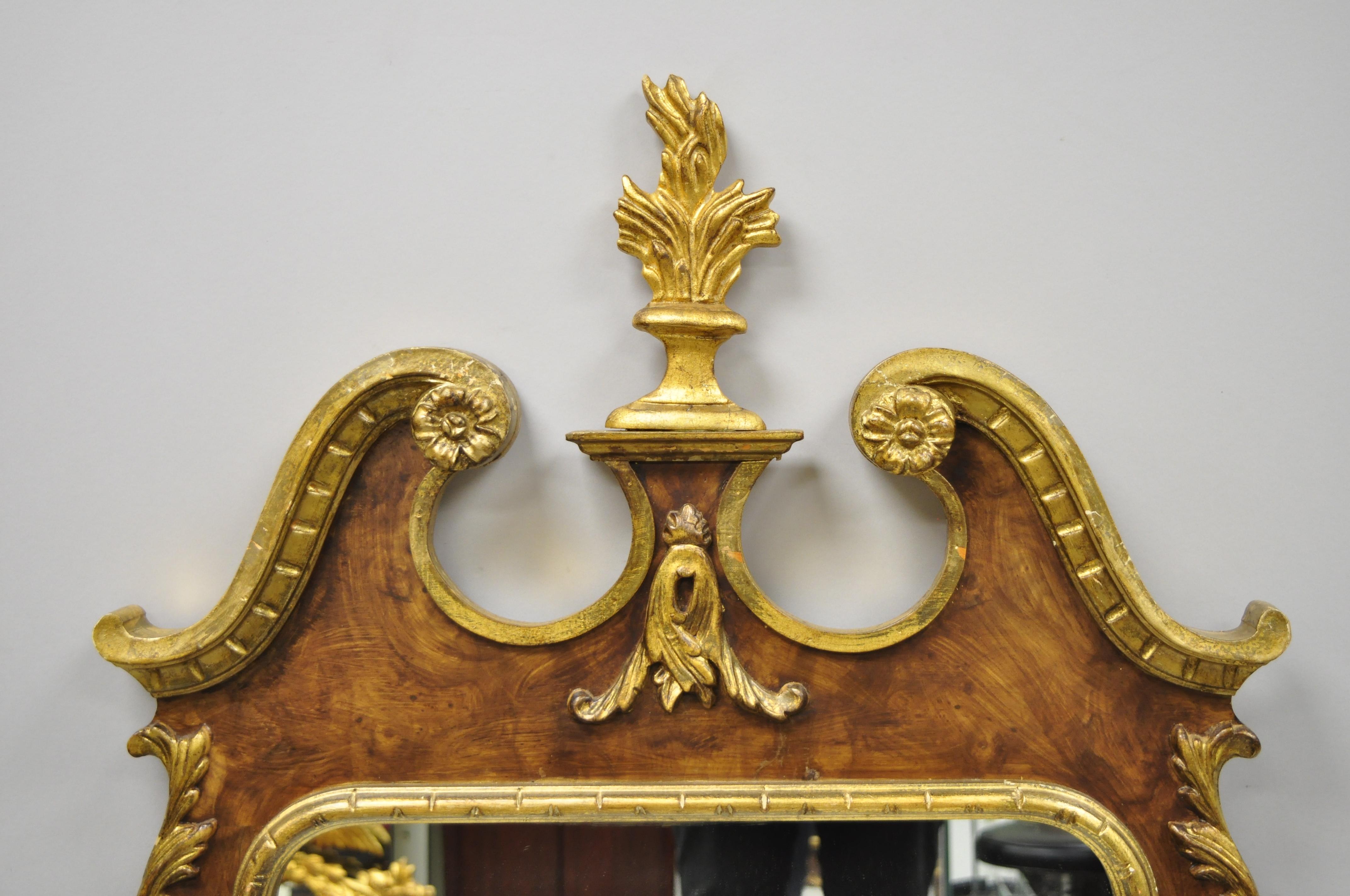 Carved wood American Federal style parcel-gilt wall mirror by Decorative Crafts Inc. Item features Gold gilt and brown distress painted finish, carved finials, solid wood frame, nicely carved details, original label, great style and form, circa late