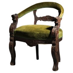 Carved wood and khaki green velvet armchair