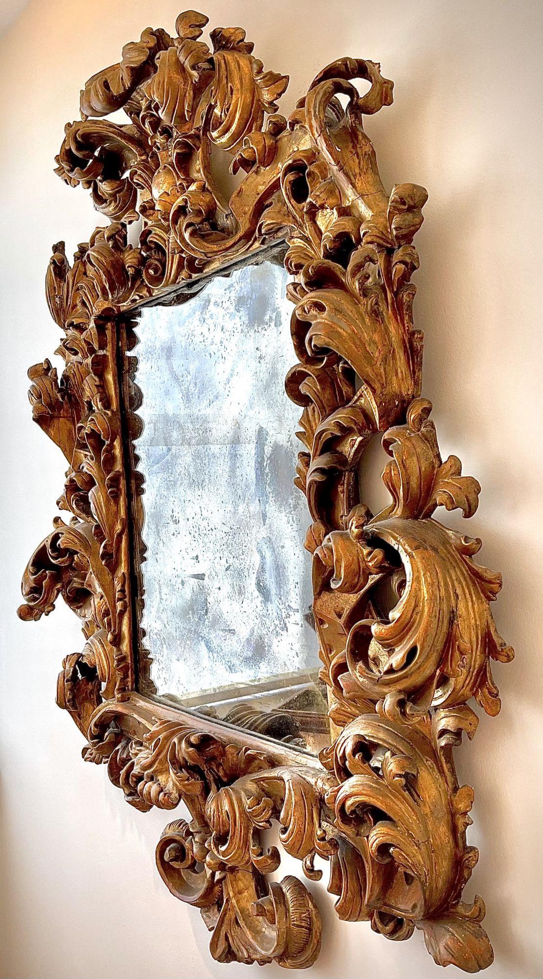 A Palatial and Museum quality Italian 18th century Florentine Rococo gilt wood carved mirror frame. The ornately carved frame with scrolls and acanthus, all gilt is original. Circa: Florence, 1770-1780.