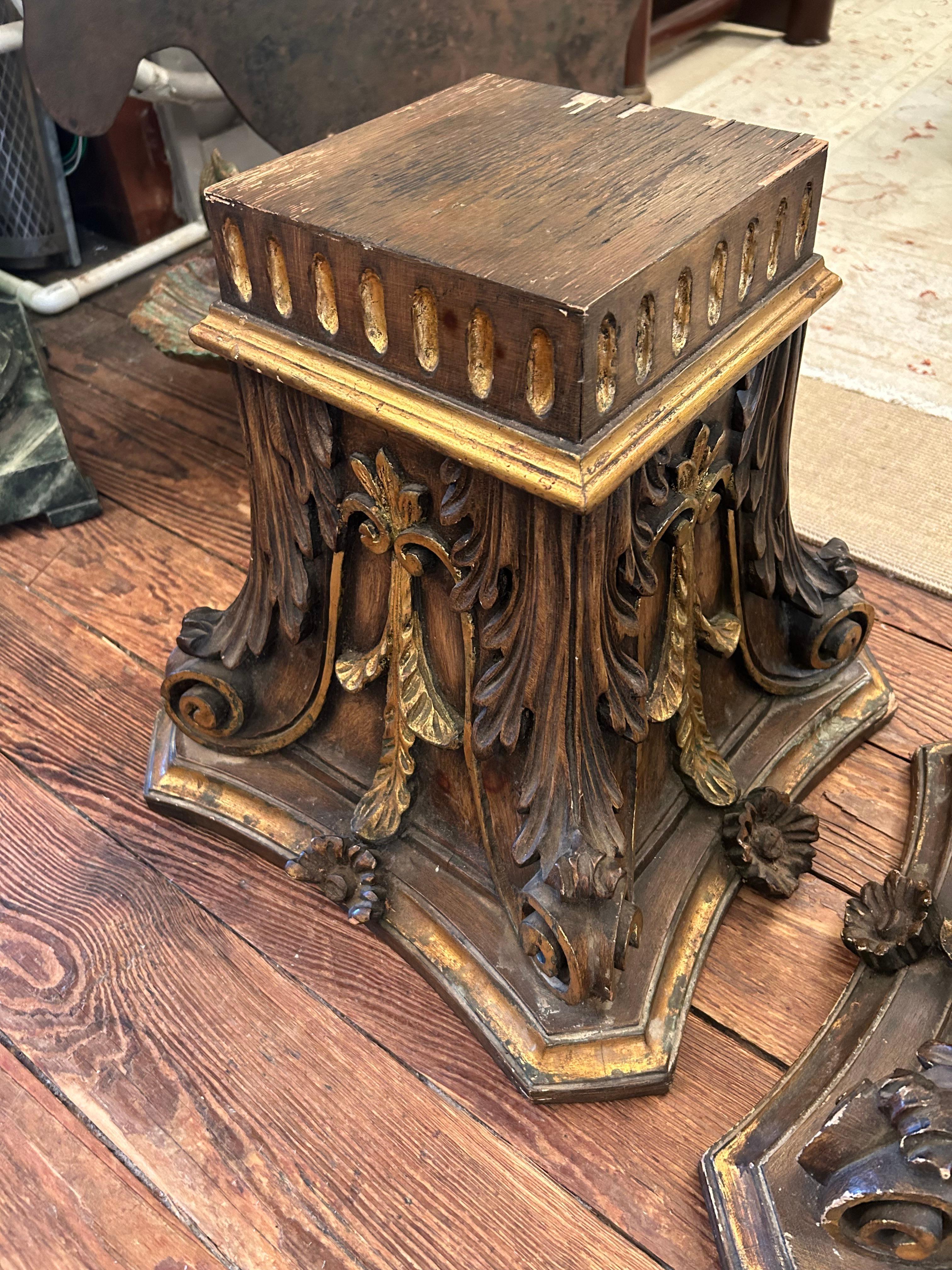 Pair of carved wood neoclassical architectural elements that would make unexpected characterful drinks tables or pedestals for a glass coffee table.  
Some vestiges of gilding here and there.
Surface of top 8.75 square