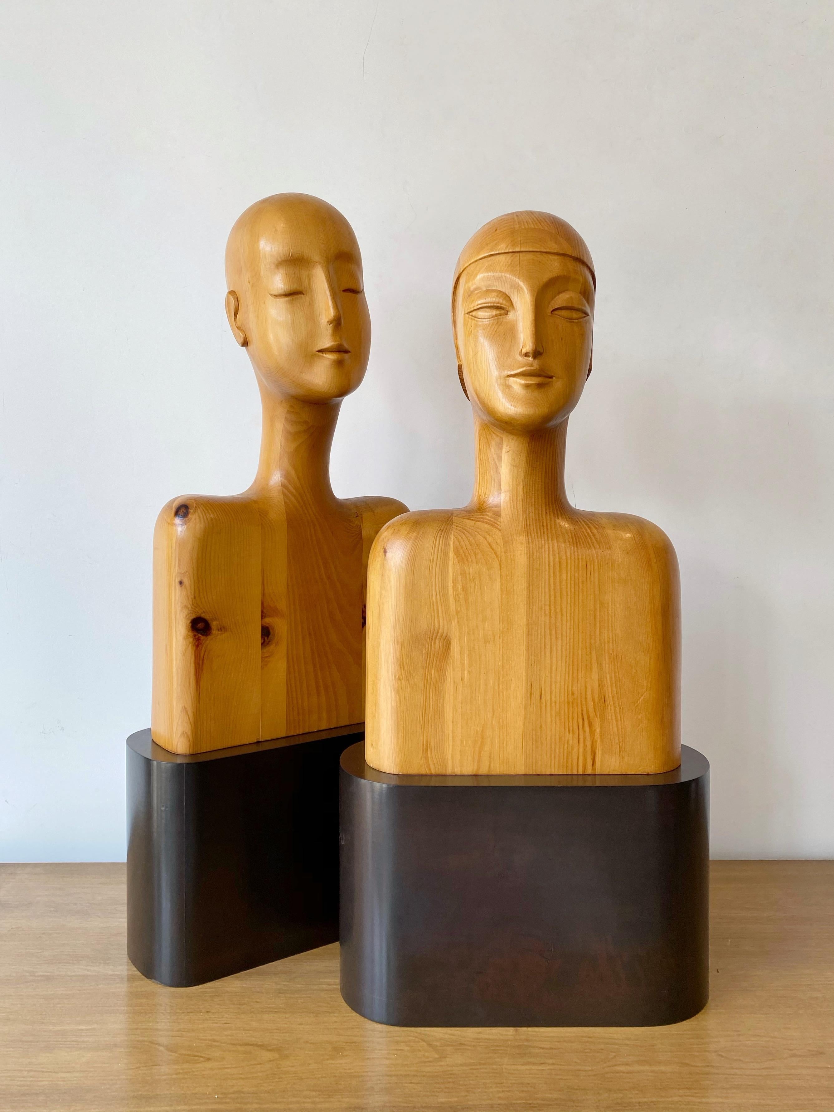 Fabulous Art Deco style carved pine busts. Male and female forms. Solid wood busts. Wood plinth bases. Busts simply set atop the bases to be separated if desired. No signature found.

Bases (each): 14.5” W x 6” D x 9” H
Bust of woman: 12” W x 8”