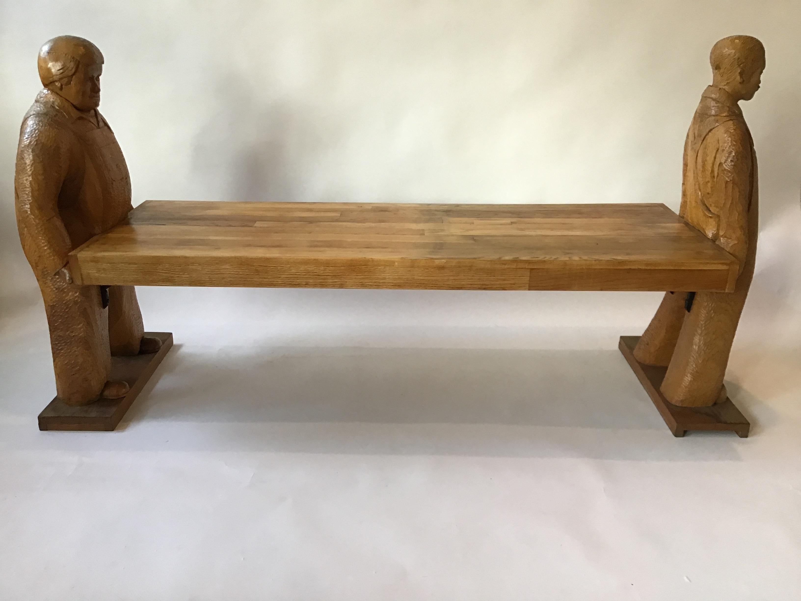 Two workers carrying a plank of wood. Hand carved wood. Can be used either as a table or bench. Signed on the bottom. Out of a Southampton, NY estate.