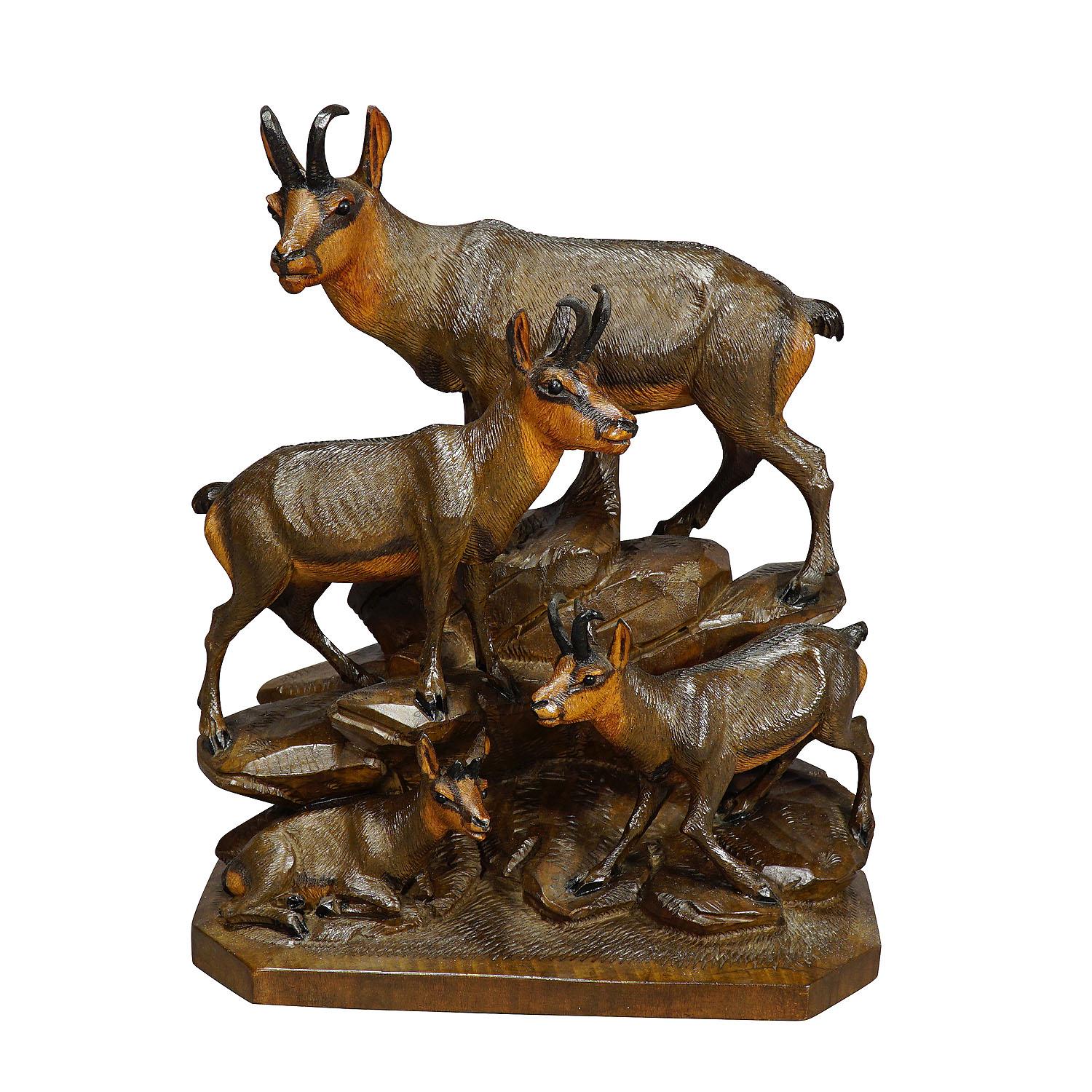 A handcarved wooden sculpture of a chamois group with buck, chamois and fawn. A very fine and natural carving by the Austrian woodcarver Ernst Heissl, ca. 1900.

Measures: width: 7.87