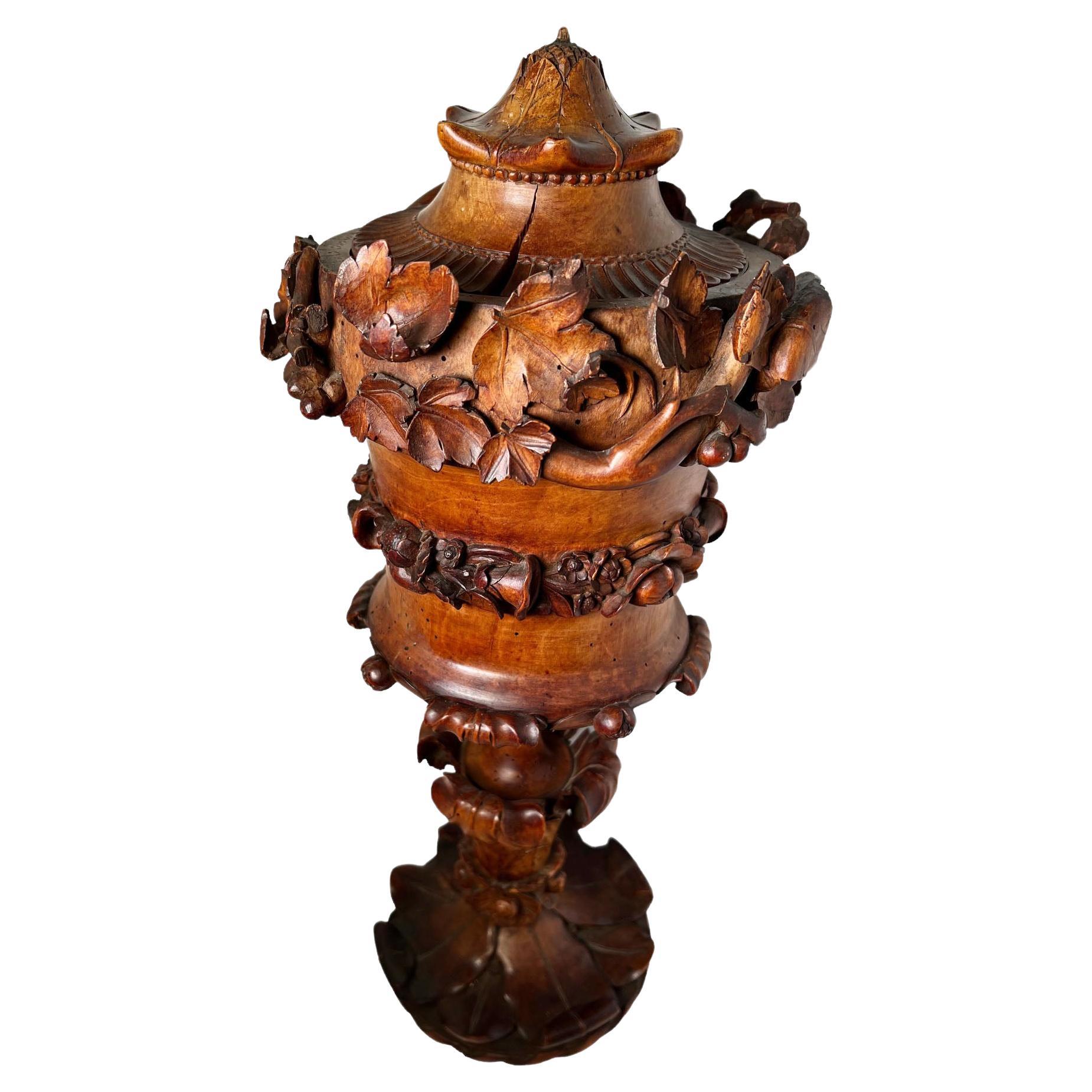 Swiss or German carved cup with lid circa 1780 to 1810. Three pieces of wood with high relief Carved leaves grapes etc.